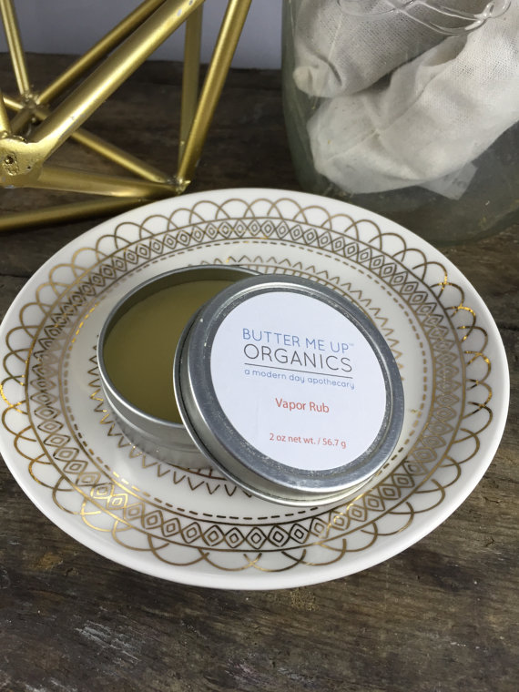 A 2 oz. tin of Handmade Organic Vapor Rub featuring a blend of essential oils, olive oil, and beeswax, promoting natural relief from congestion.