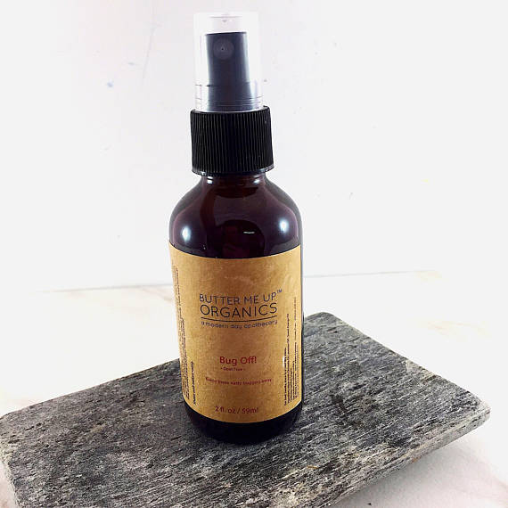 A bottle of Organic Bug Spray Bug Repellant featuring a natural design, showcasing its eco-friendly ingredients like Witch Hazel and essential oils.