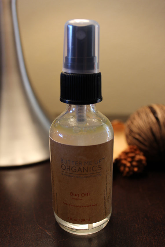 A bottle of Organic Bug Spray Bug Repellant featuring a natural design, showcasing its eco-friendly ingredients like Witch Hazel and essential oils.