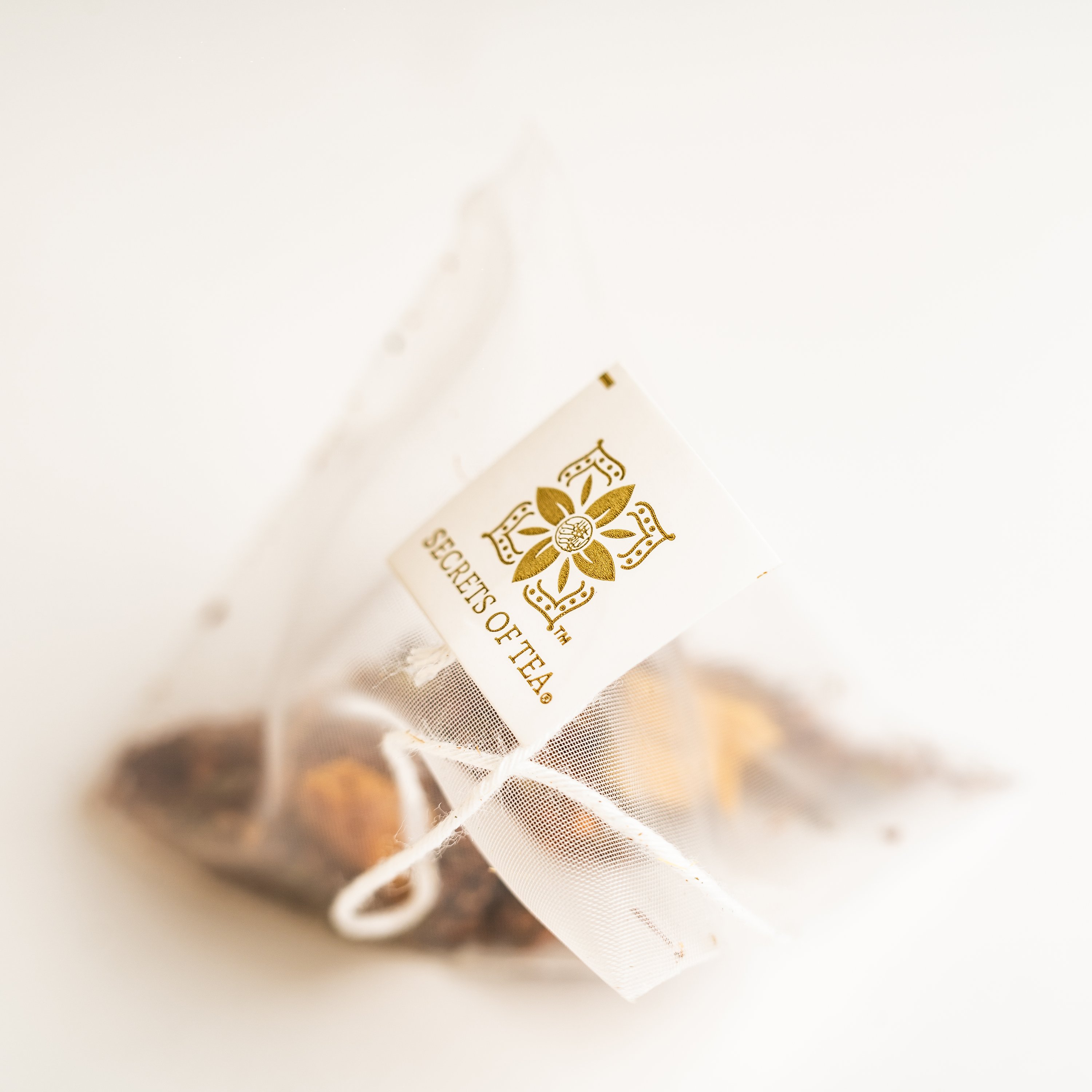 A box of Organic Slimming Herbal Tea featuring Moringa, with sachets inside, set against a natural backdrop.