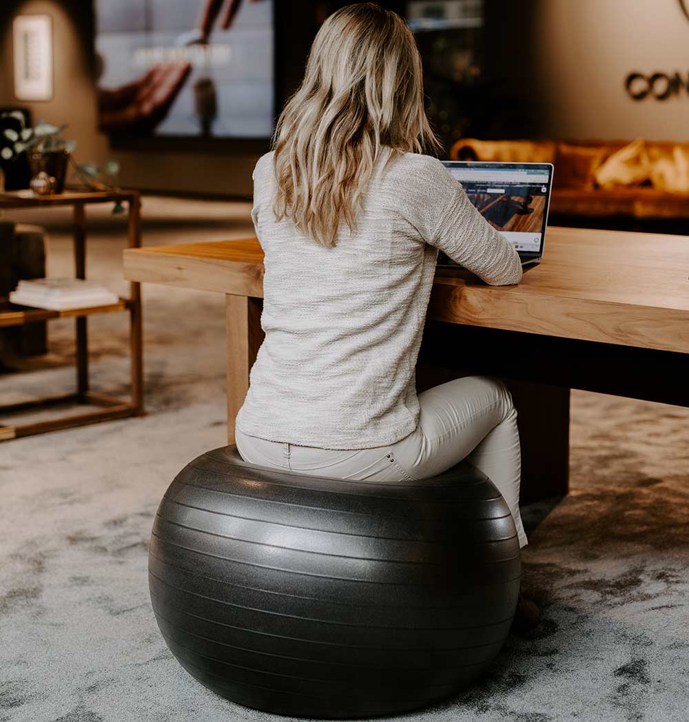 A vibrant Pilates ball with attached resistance bands, ideal for yoga and fitness exercises, placed on a gym mat.