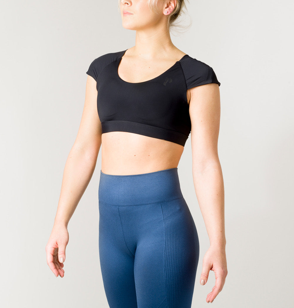 Posture Sports Top in stylish design with crossed straps, showcasing posture alignment technology for optimal support during workouts.