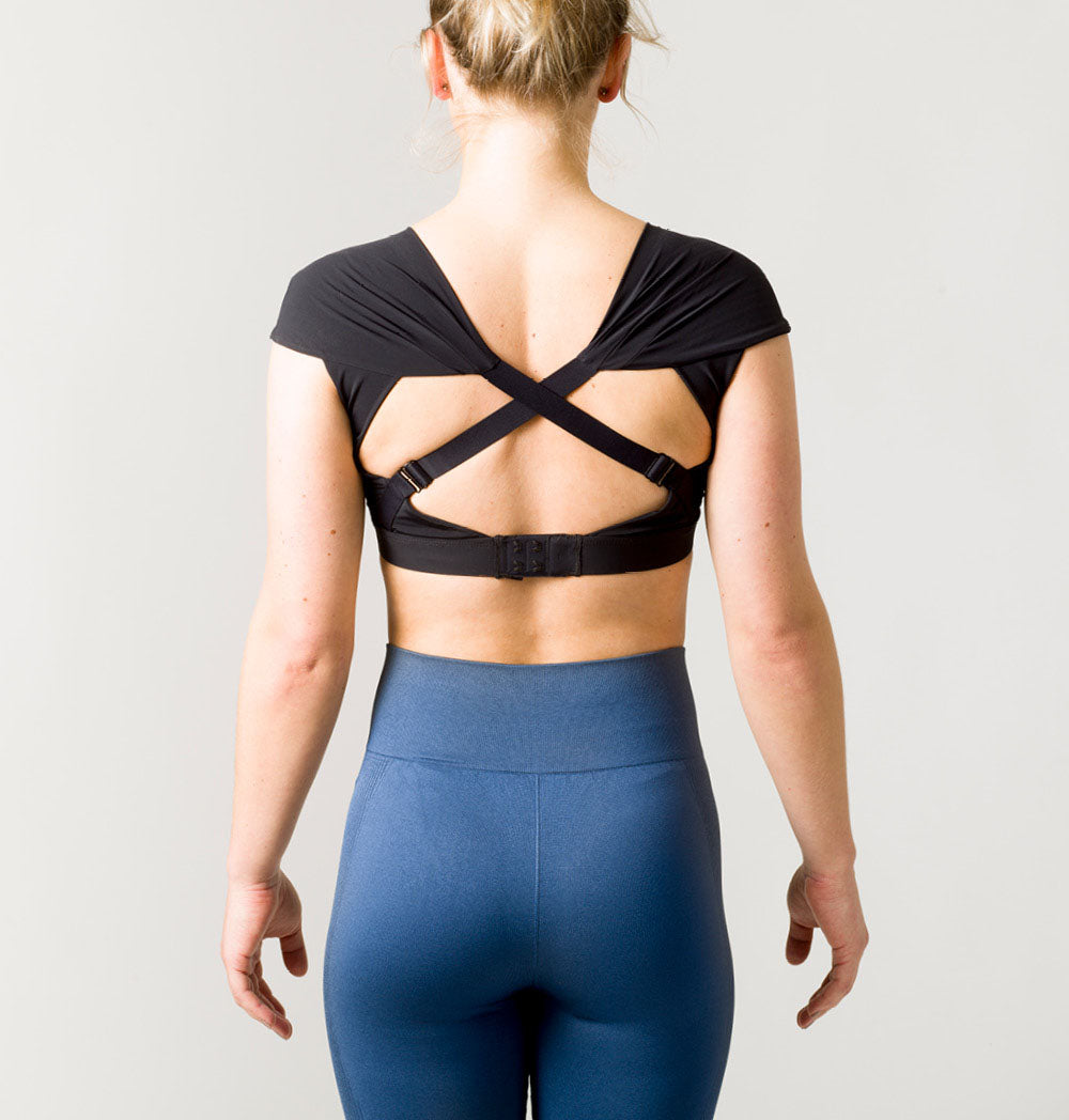 Posture Sports Top in stylish design with crossed straps, showcasing posture alignment technology for optimal support during workouts.