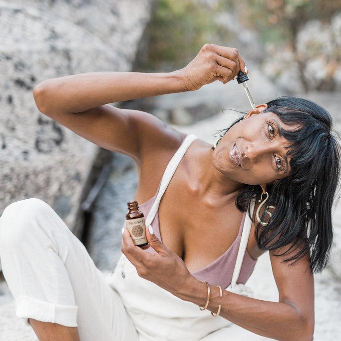 The Dinacharya Ritual kit featuring Ayurvedic self-care products including Ear Oil, Body Oil, Nose Oil, Oil Pulling Oil, and Floral Water, all in elegant packaging.