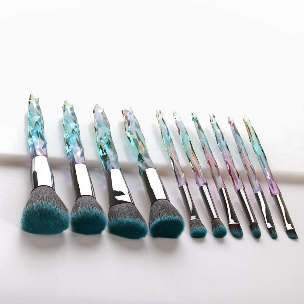 A set of 10 transparent crystal diamond makeup brushes with colorful handles, showcasing their elegant design and high-quality bristles.