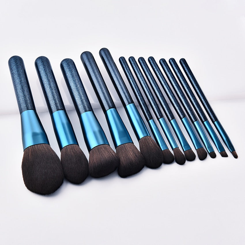 A set of 12 blue makeup brushes with soft nylon wool bristles and comfortable wooden handles, perfect for various makeup applications.