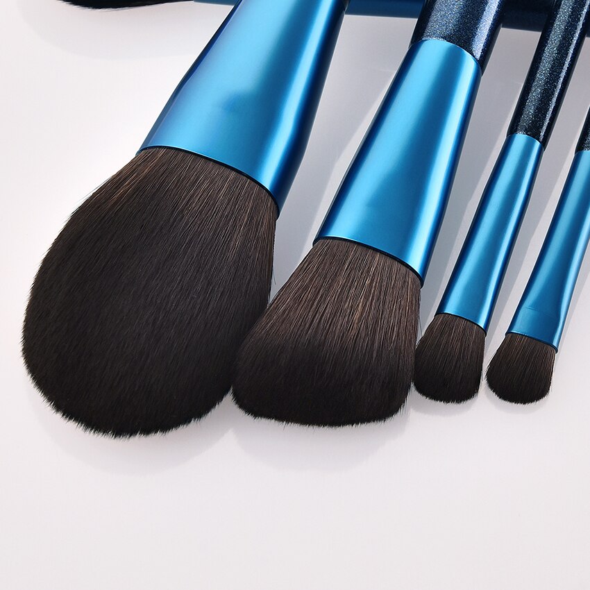 A set of 12 blue makeup brushes with soft nylon wool bristles and comfortable wooden handles, perfect for various makeup applications.