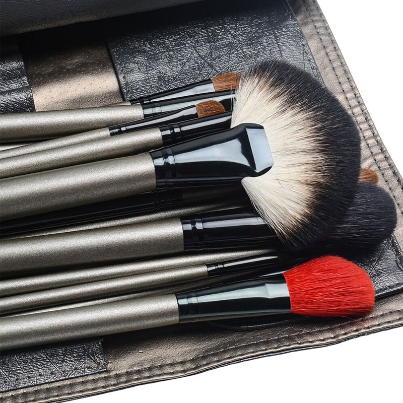 A complete set of 26 high-quality makeup brushes displayed in a stylish leather holder case, showcasing various brush shapes and sizes.