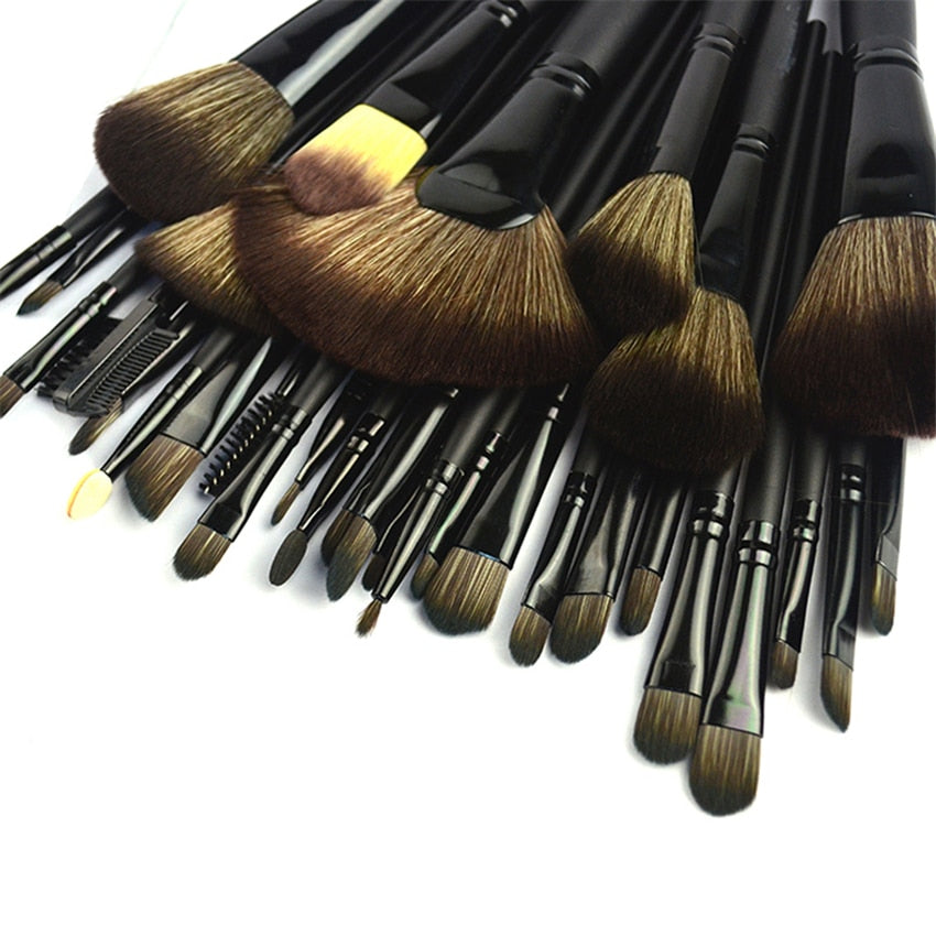 32-piece black professional makeup brushes set with wooden handles and nylon bristles, packaged for travel convenience.