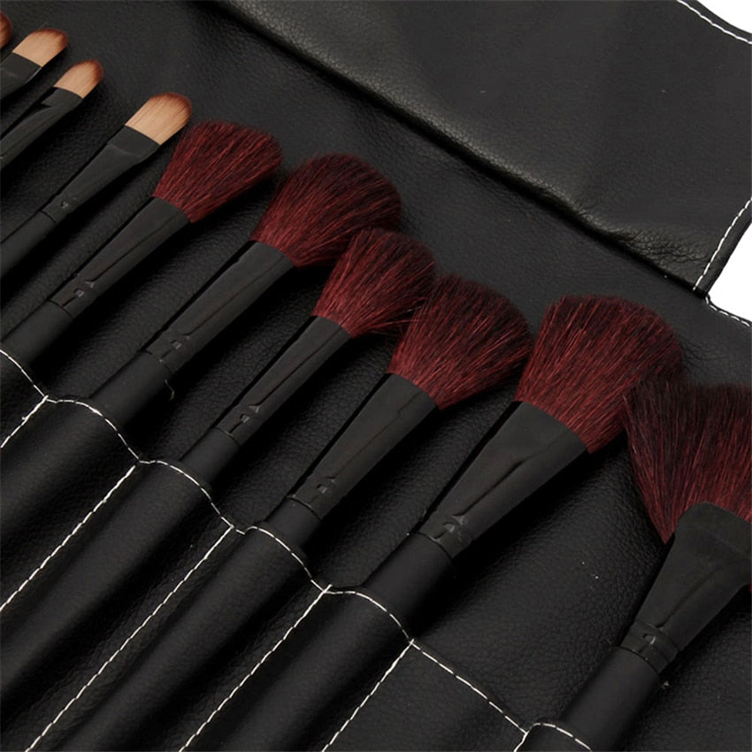 32-piece black professional makeup brushes set with wooden handles and nylon bristles, packaged for travel convenience.