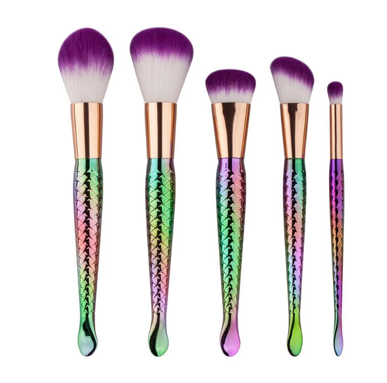 A set of 5 mermaid-themed makeup brushes with colorful handles and soft bristles, perfect for makeup application.