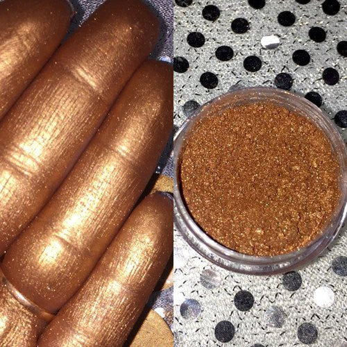 Bronze Goddess Loose Diamond Highlighter in a sleek container, showcasing its finely milled bronze gold powder with golden specks.