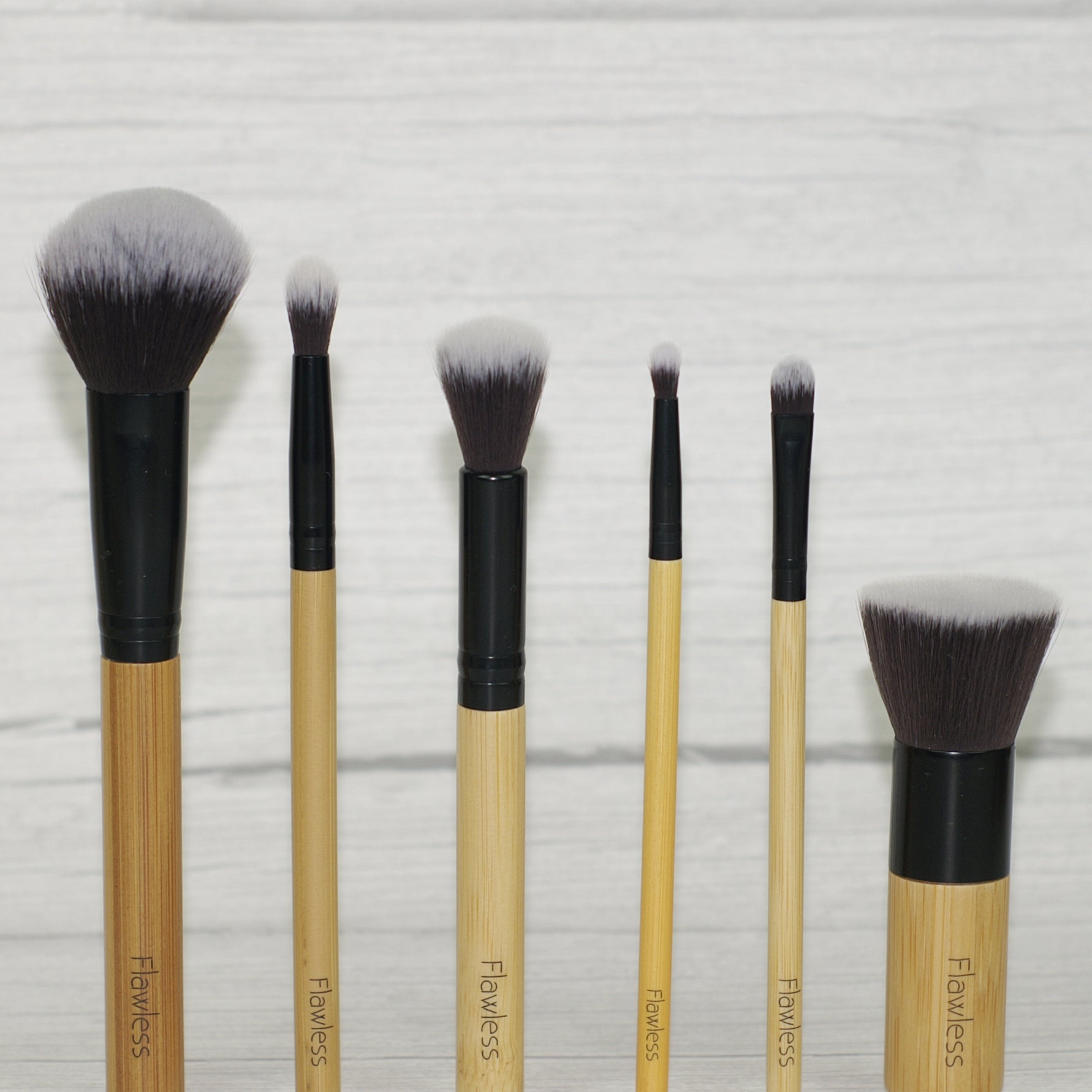 Dewy Skin Bamboo Brush Set featuring six soft brushes with bamboo handles and an organic cotton storage bag.