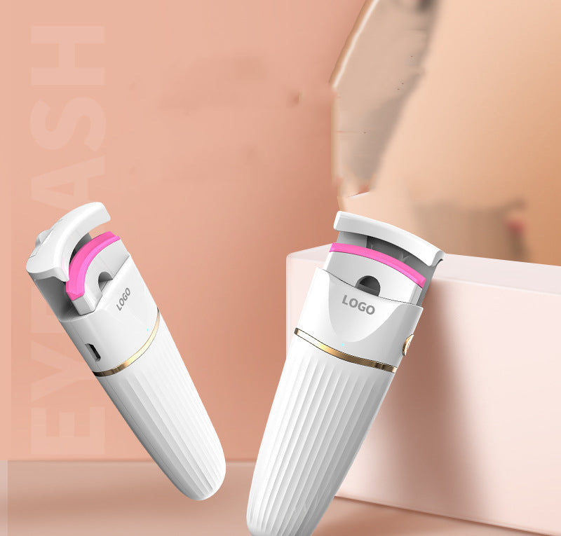 Electric eyelash curler in white, pink, and blue colors, showcasing its sleek design and compact size.