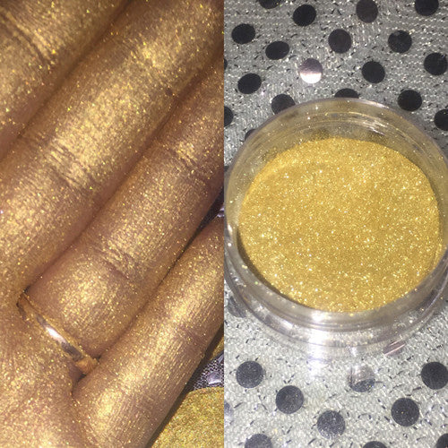 Glow Digger Loose Diamond Highlighter in shimmering yellow gold powder form, showcasing its finely milled texture and elegant packaging.