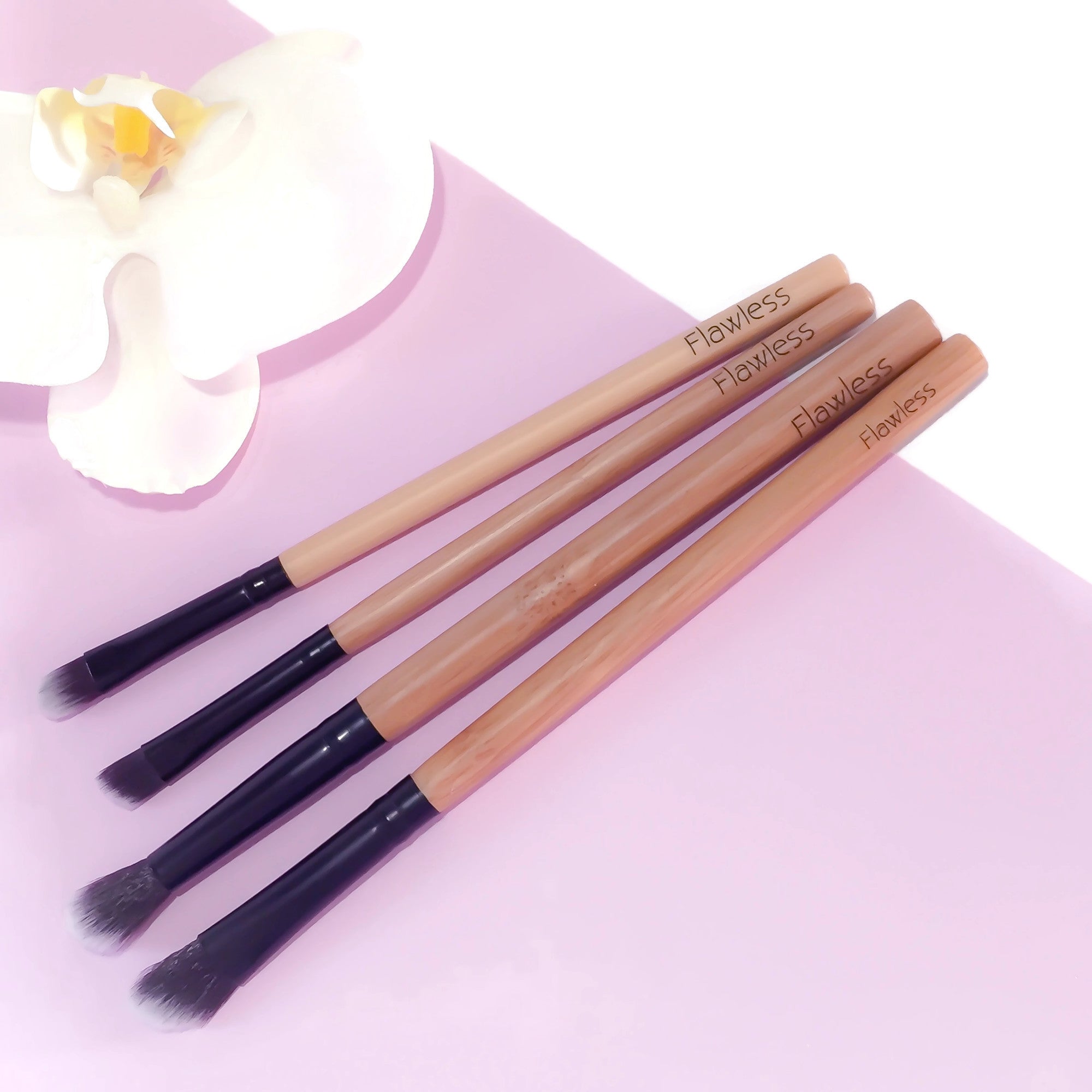 A four-piece vegan makeup brush set with bamboo handles, designed for eye makeup application, featuring angled and blending brushes.