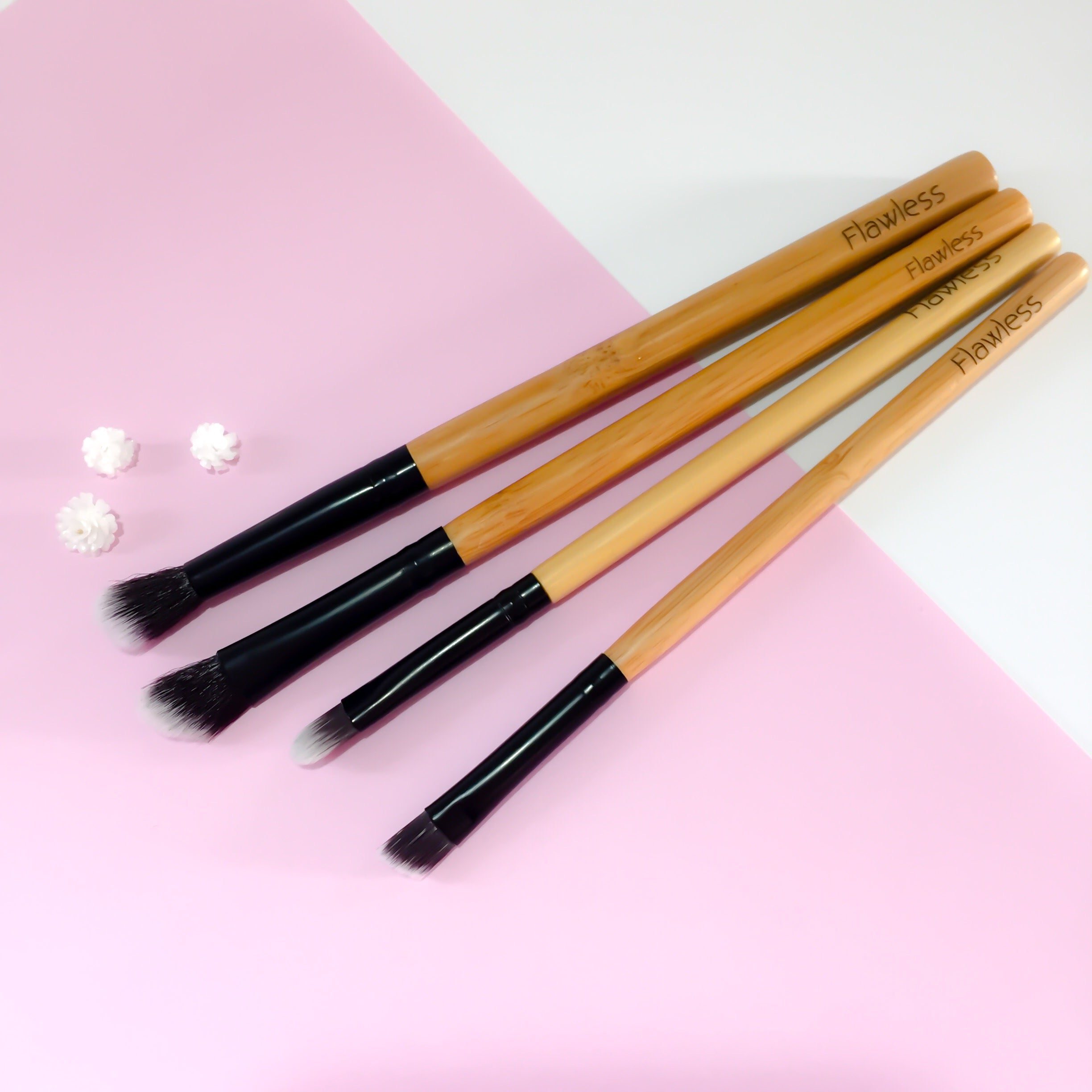 A four-piece vegan makeup brush set with bamboo handles, designed for eye makeup application, featuring angled and blending brushes.