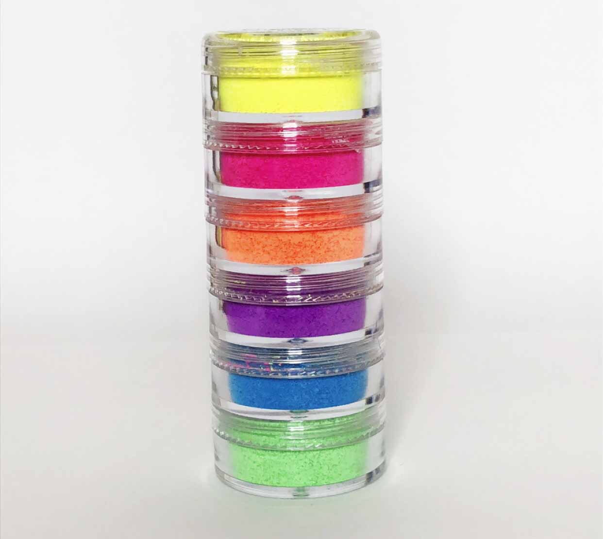 A vibrant stack of six neon pigments in assorted colors including yellow, green, pink, purple, orange, and blue, perfect for bold makeup looks.