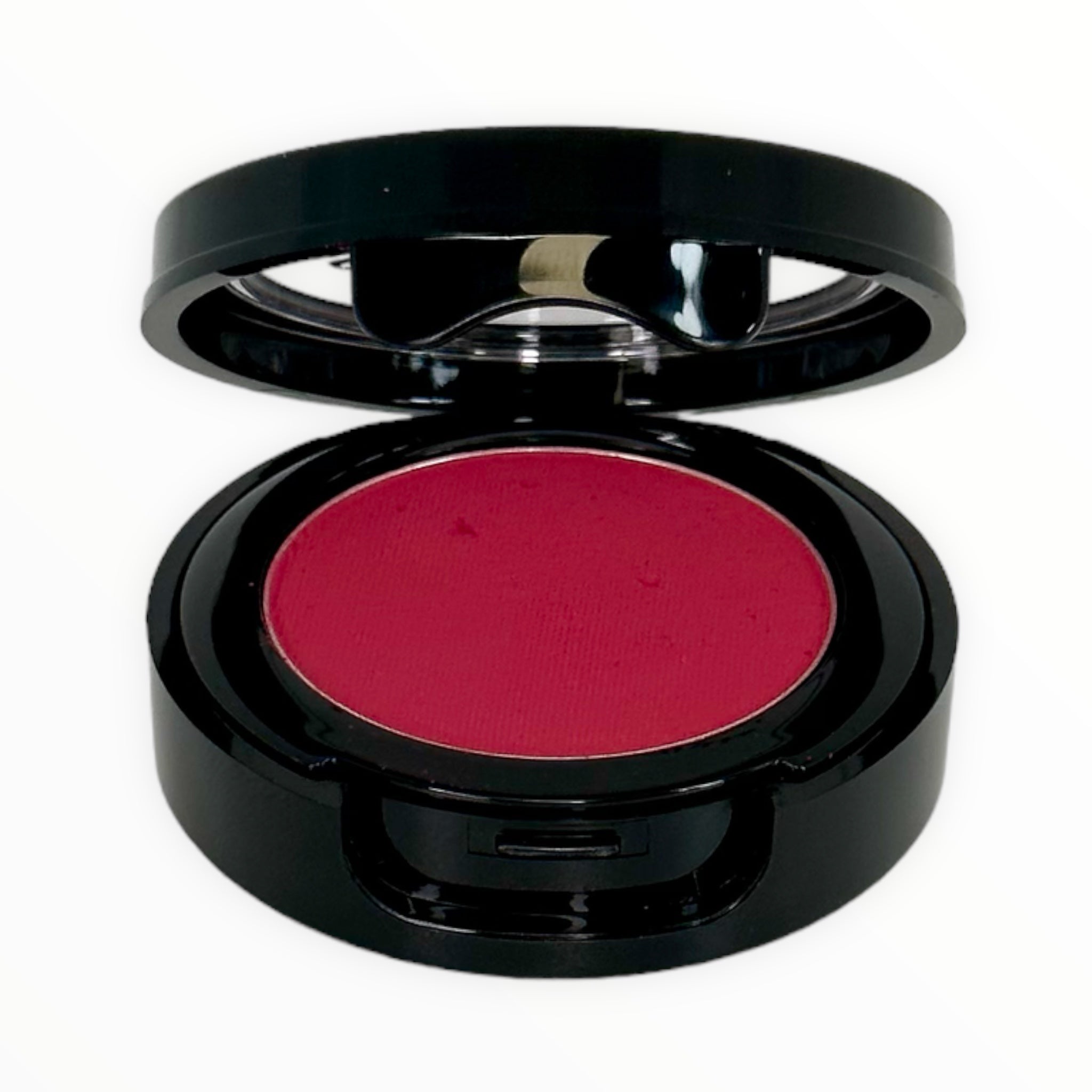 A vibrant PARTY-BRIGHT CORAL RED matte powder blush in a sleek container, perfect for adding color to cheeks.