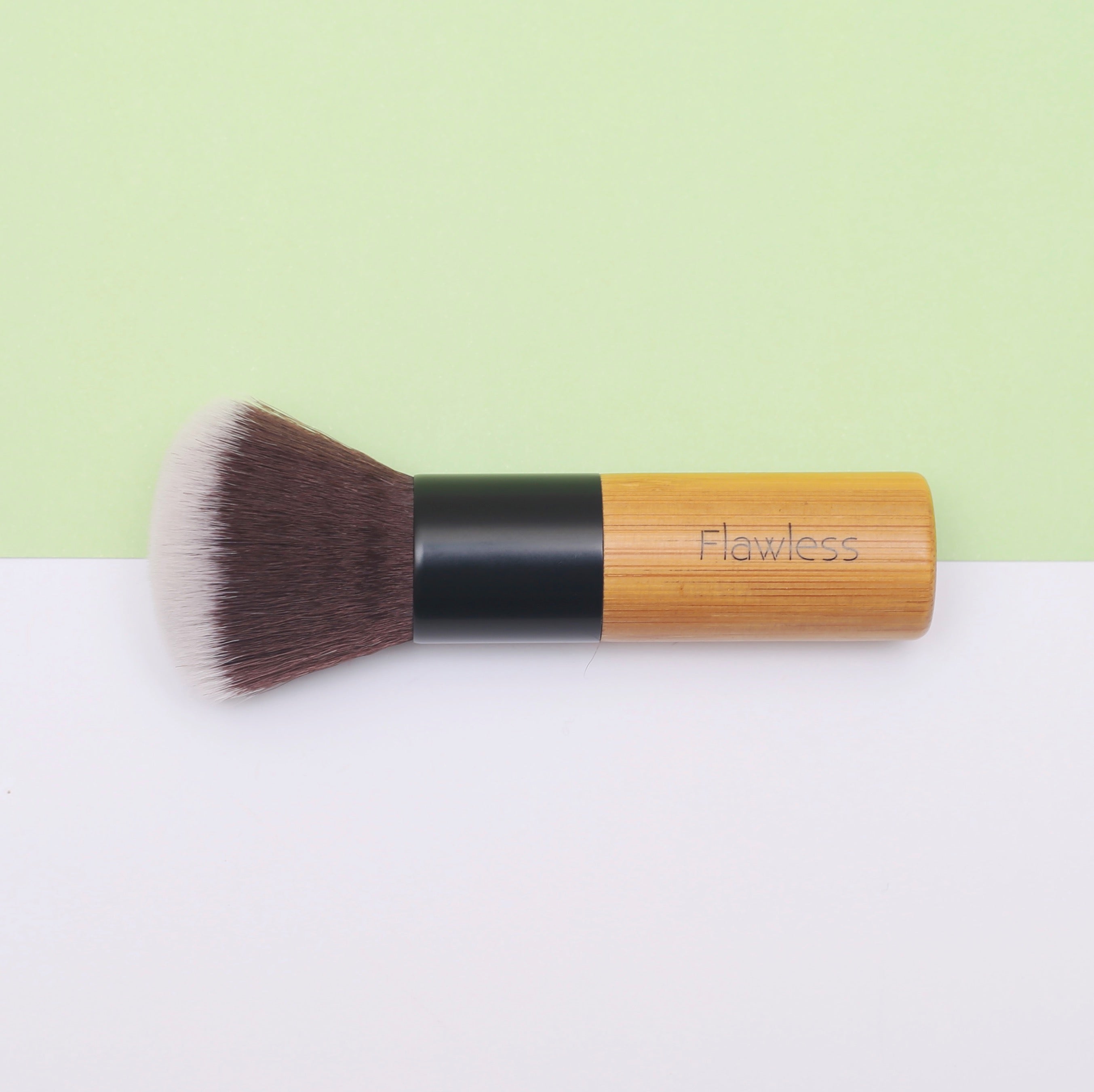 A high-quality Powder/Blusher Brush with a bamboo handle and soft synthetic bristles, ideal for blending powders.