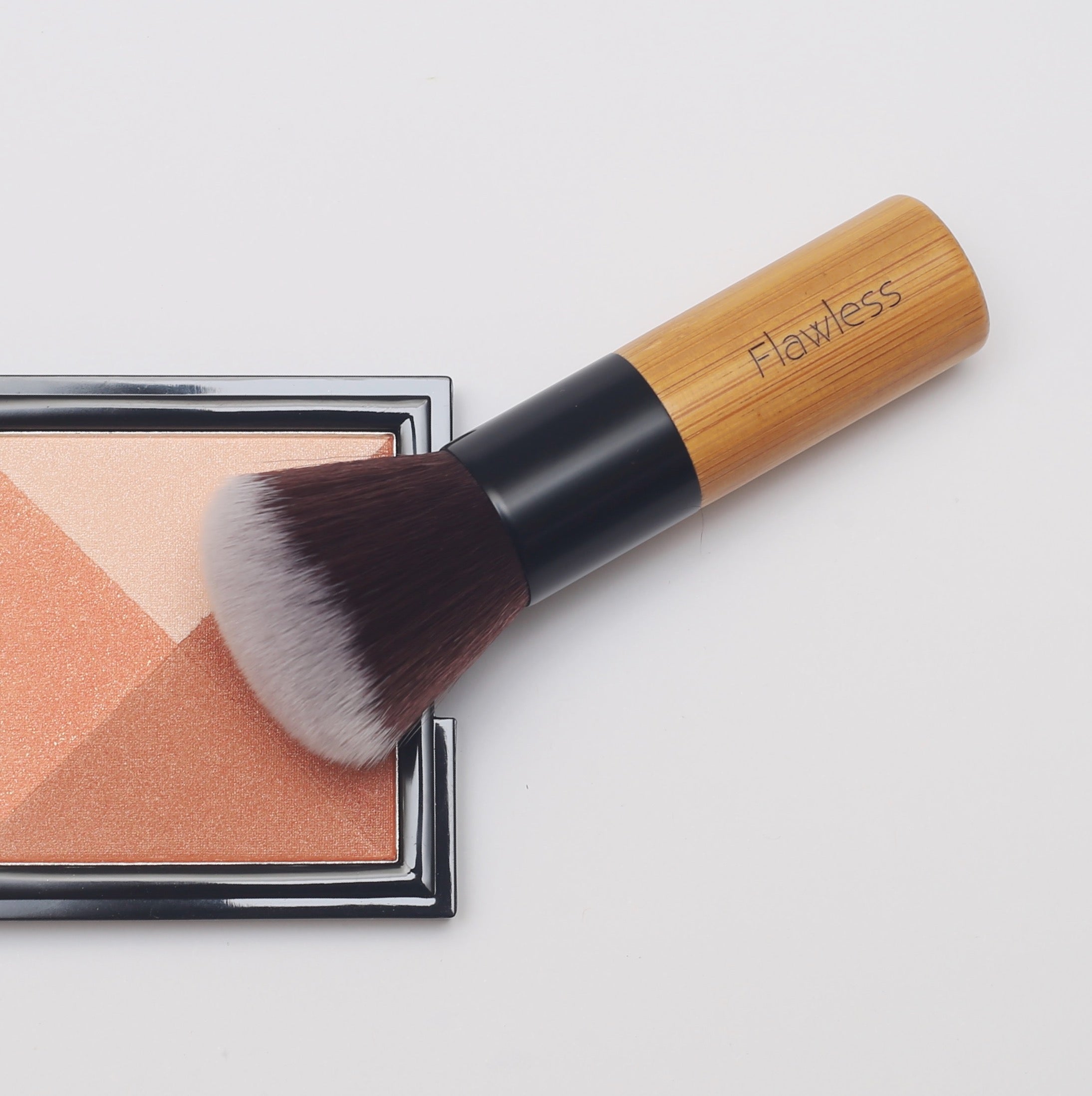 A high-quality Powder/Blusher Brush with a bamboo handle and soft synthetic bristles, ideal for blending powders.