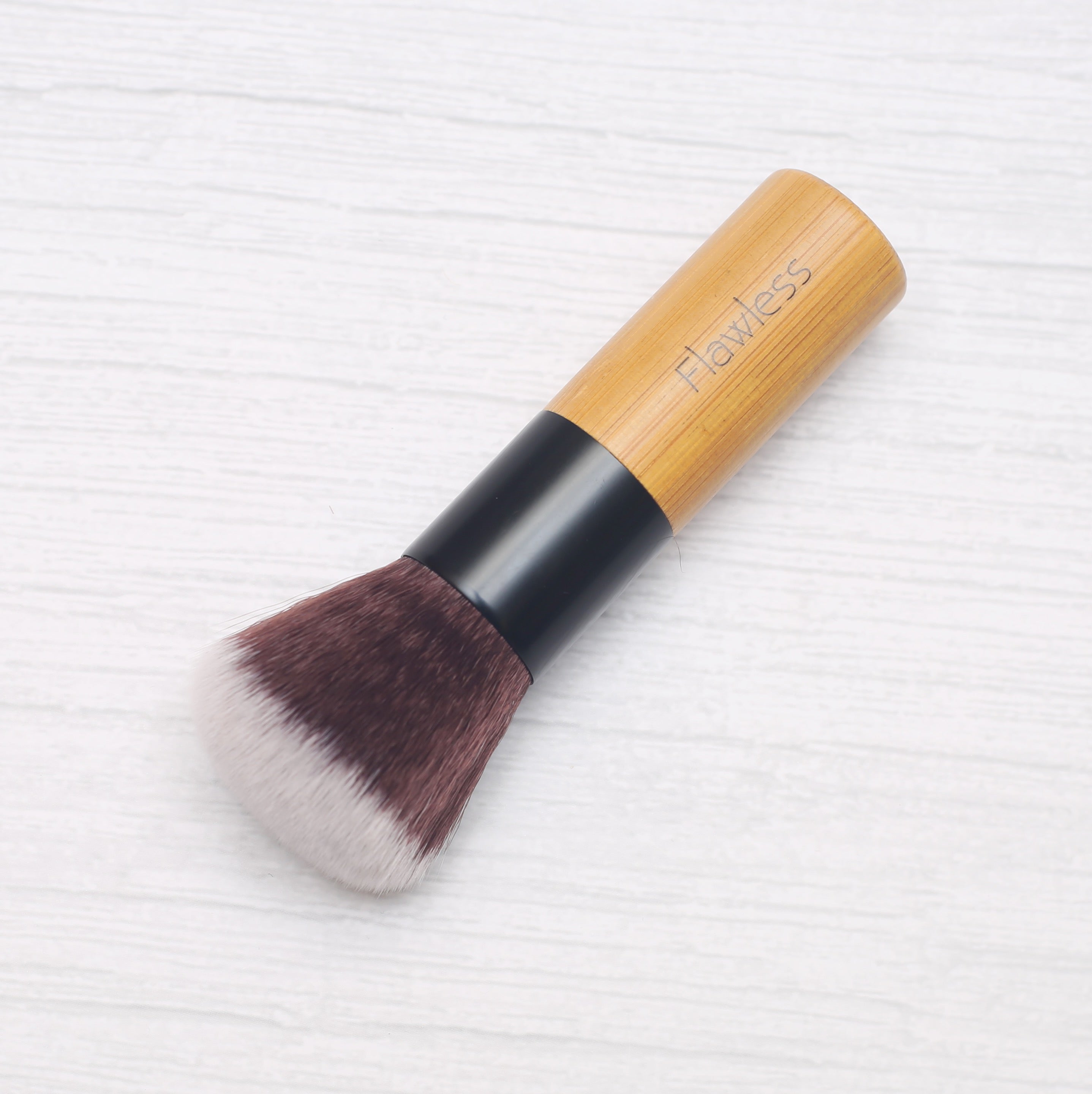 A high-quality Powder/Blusher Brush with a bamboo handle and soft synthetic bristles, ideal for blending powders.