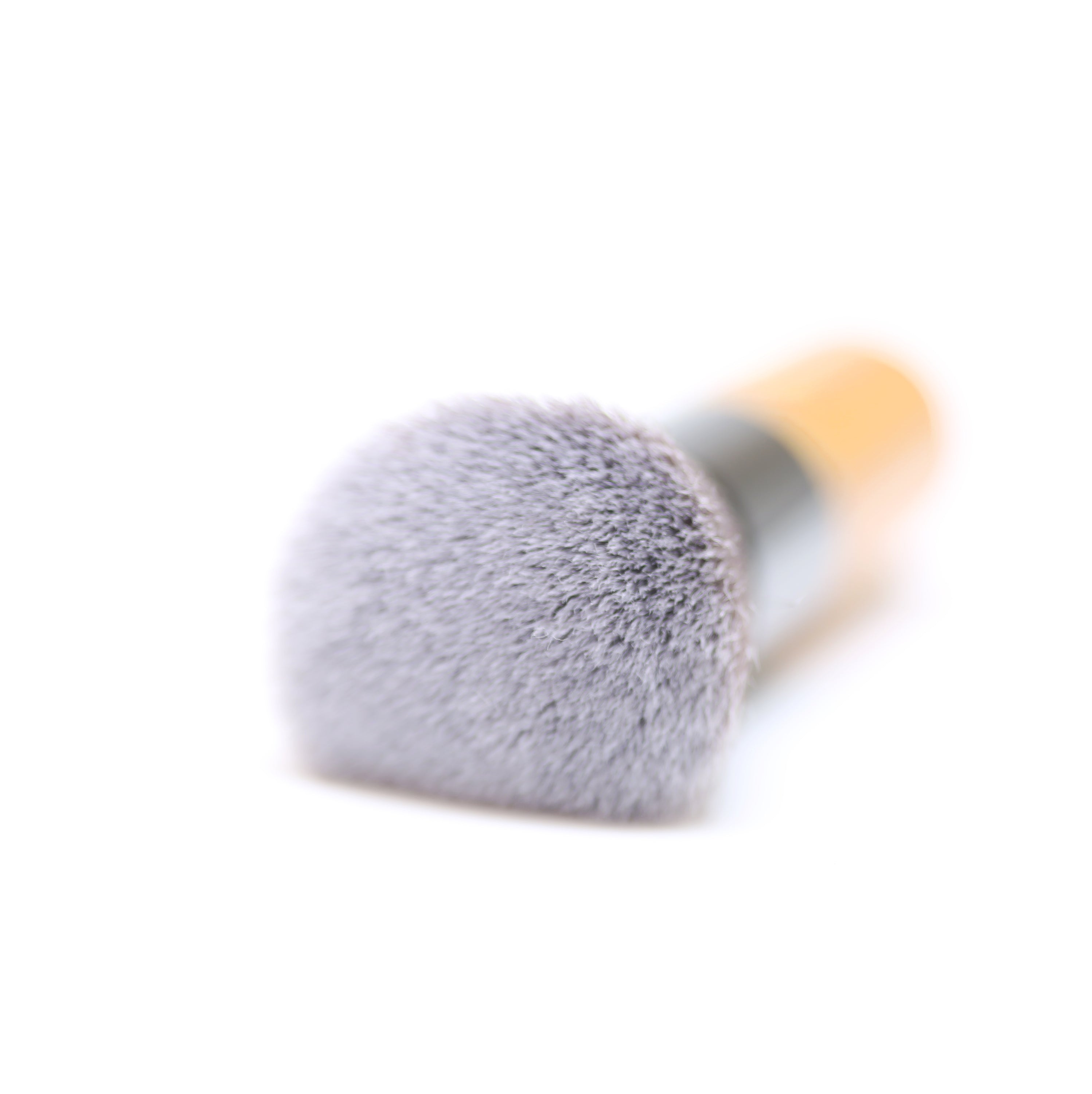 A high-quality Powder/Blusher Brush with a bamboo handle and soft synthetic bristles, ideal for blending powders.