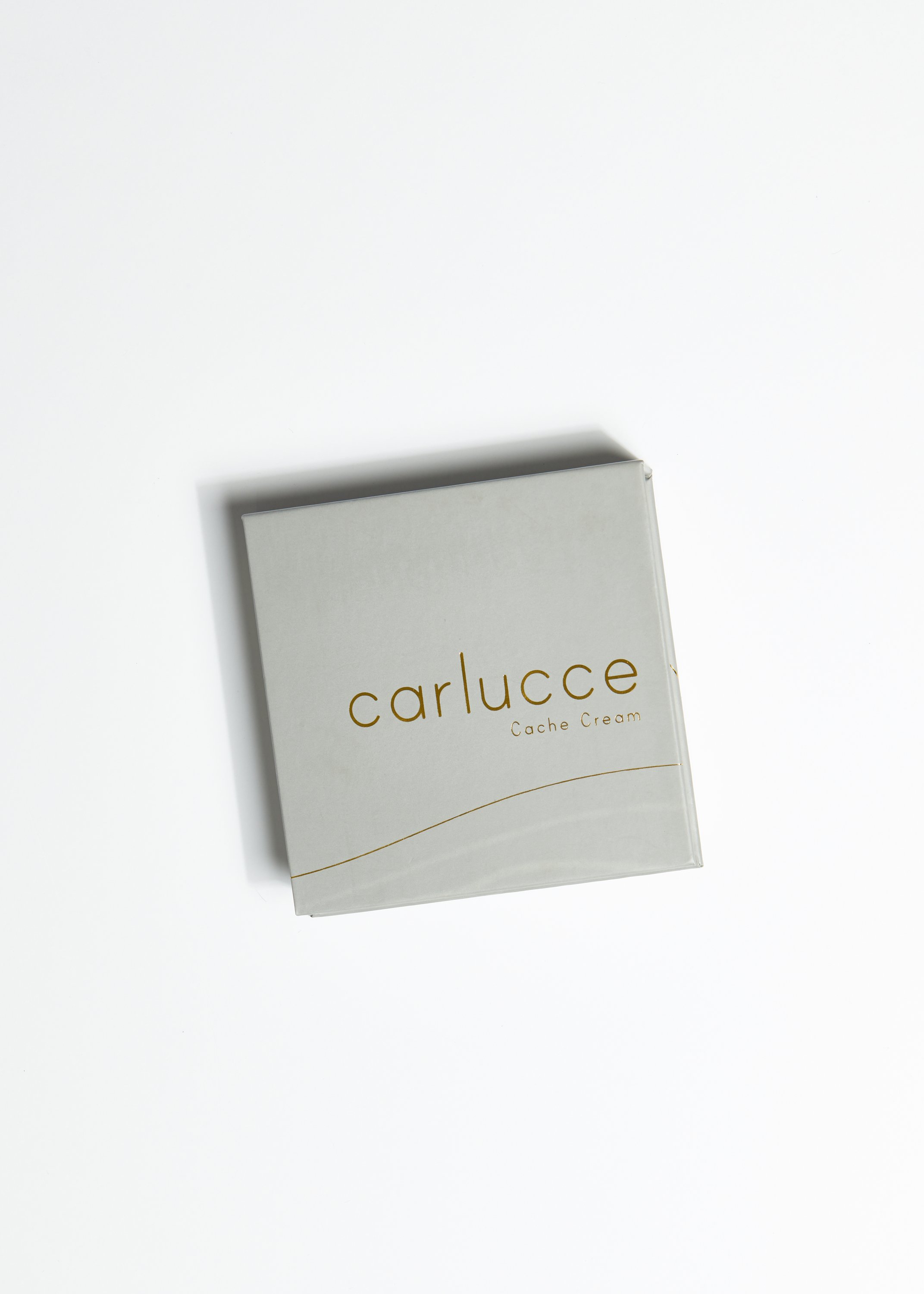 Raw - Cache Cream™ in a sleek container, showcasing its light to medium neutral beige shade, perfect for all skin tones.