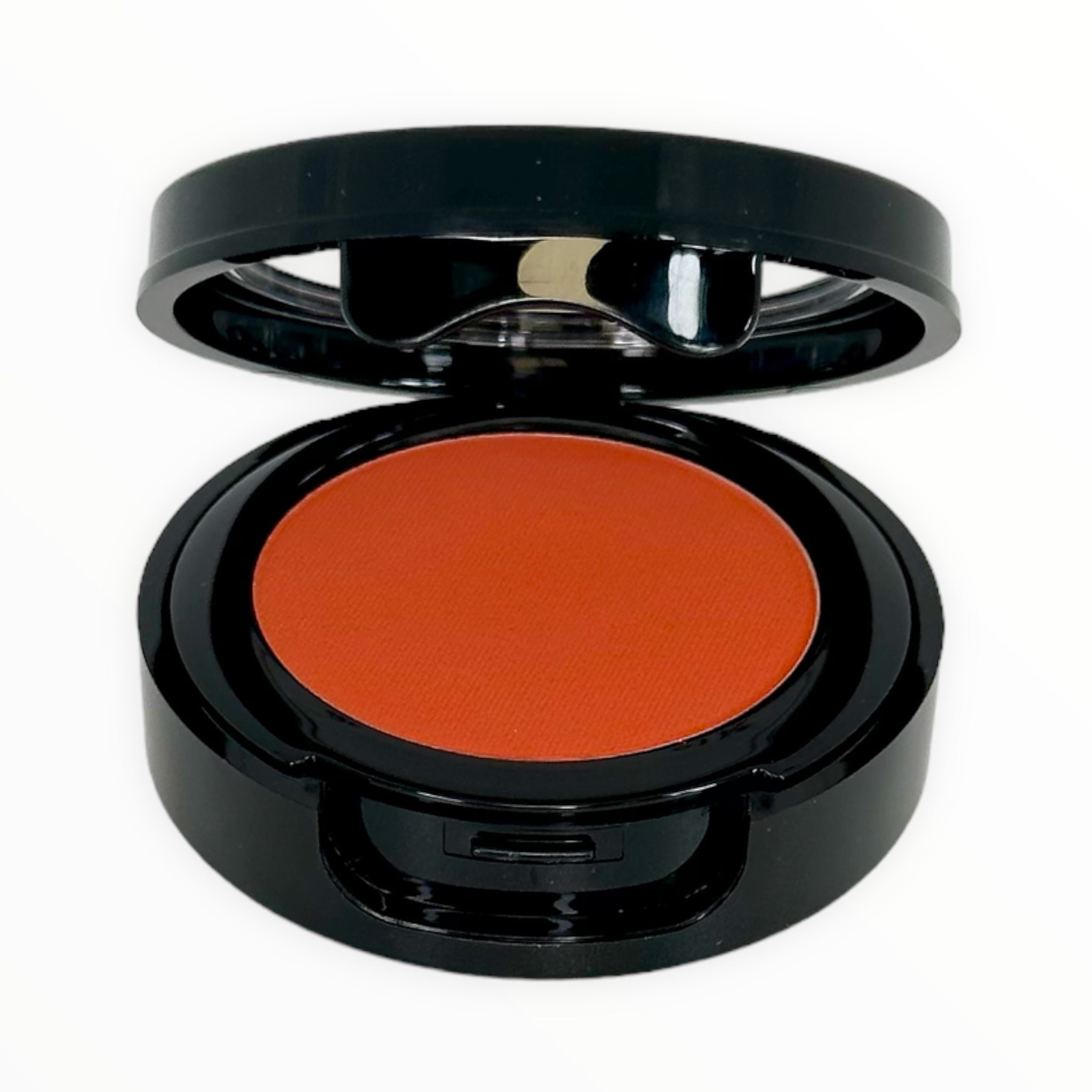 SUNKIST-BRIGHT RED ORANGE matte powder blush in a compact, showcasing its vibrant red-orange color.