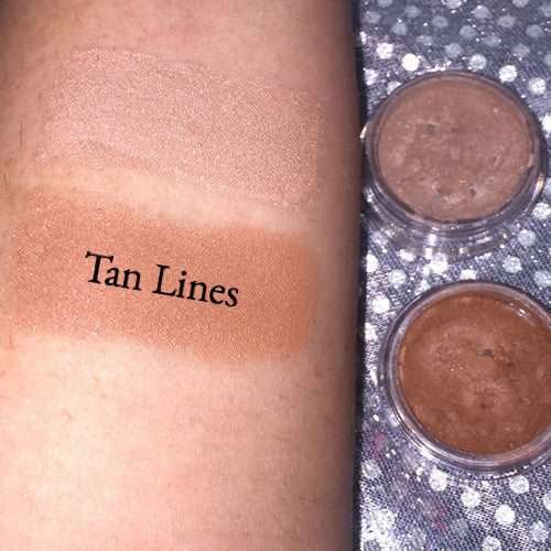 Tan Lines Pigment Bronzer in a loose powder form, showcasing its natural mineral pigment and demi-matte texture.