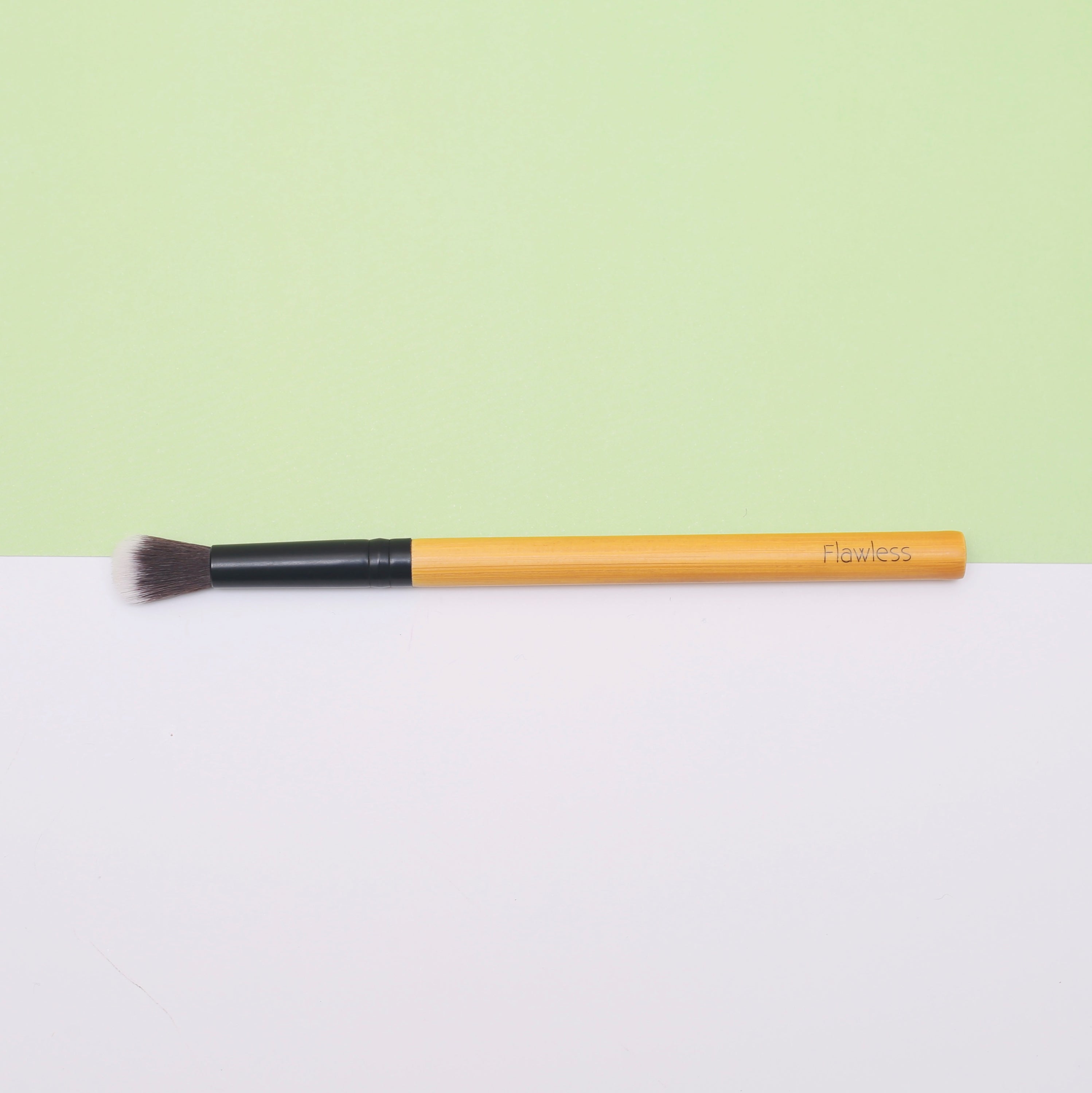 THE Bamboo Blending Makeup Brush with soft bristles and a bamboo handle, designed for flawless blending of concealers and eyeshadows.