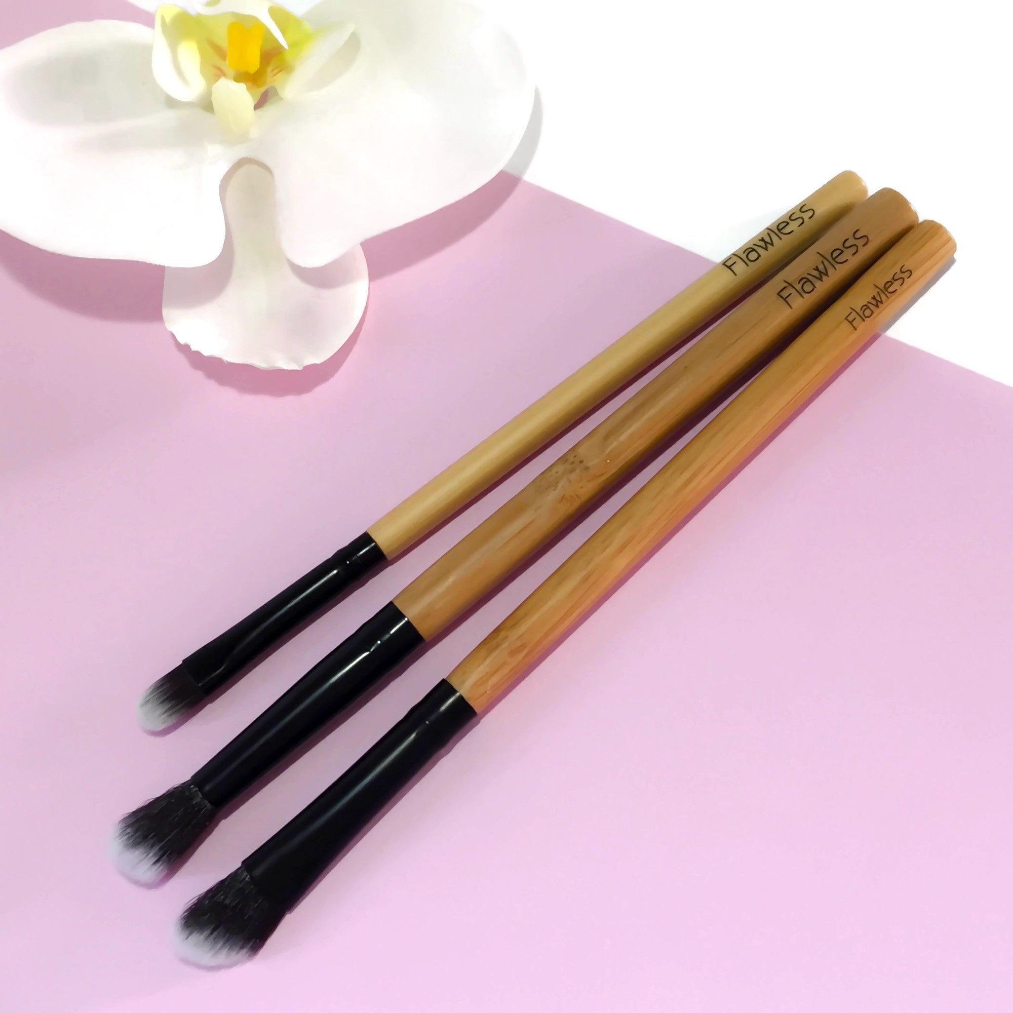 The Trilogy Eye Brush Set featuring three essential brushes for eyeshadow application and blending, showcasing a small flat brush, blending brush, and angled blending brush.