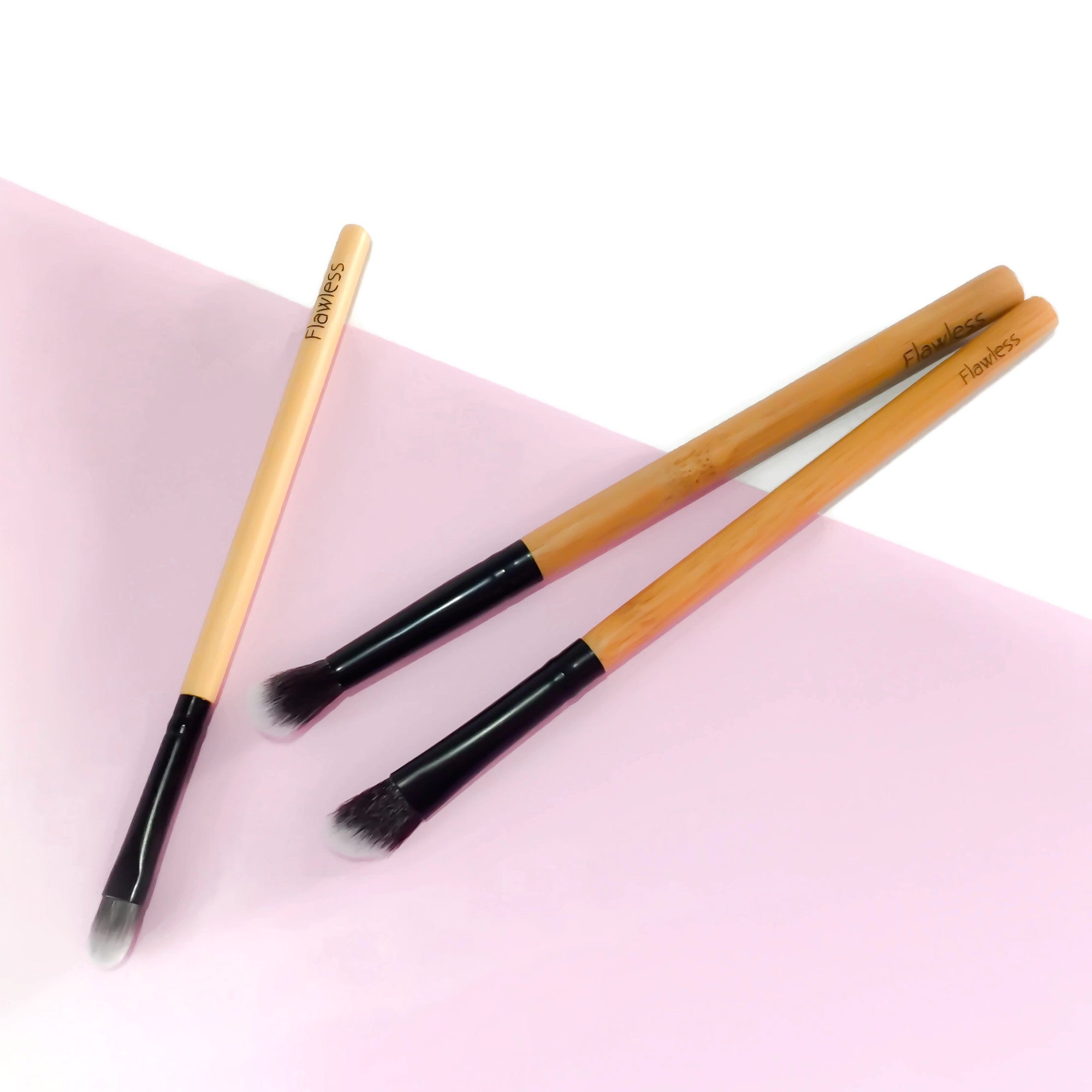 The Trilogy Eye Brush Set featuring three essential brushes for eyeshadow application and blending, showcasing a small flat brush, blending brush, and angled blending brush.