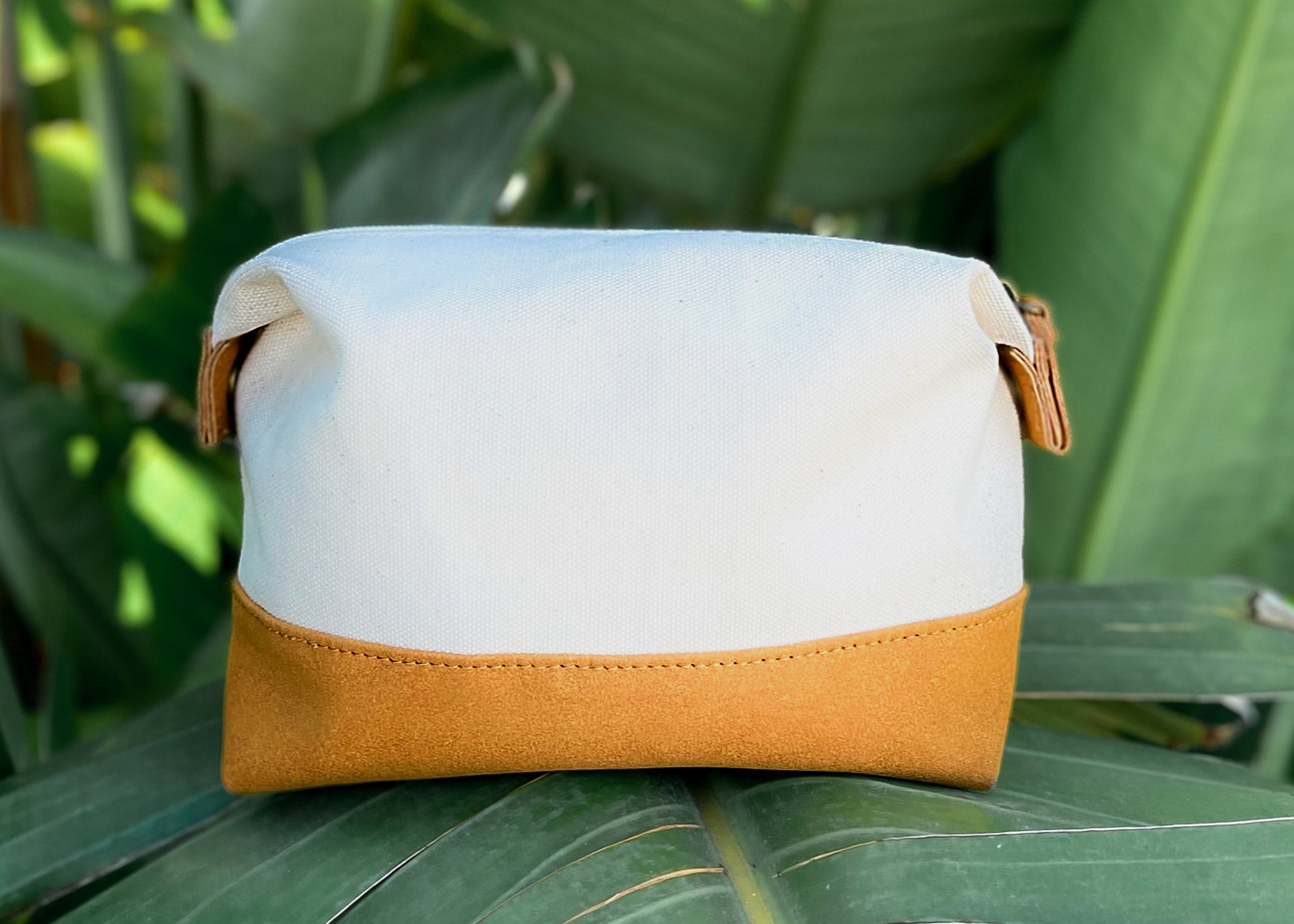 Travel Buddy Toiletry Bag in Bliss Curry/Cream, featuring a stylish design with snap-down sides and a secure zipper compartment.