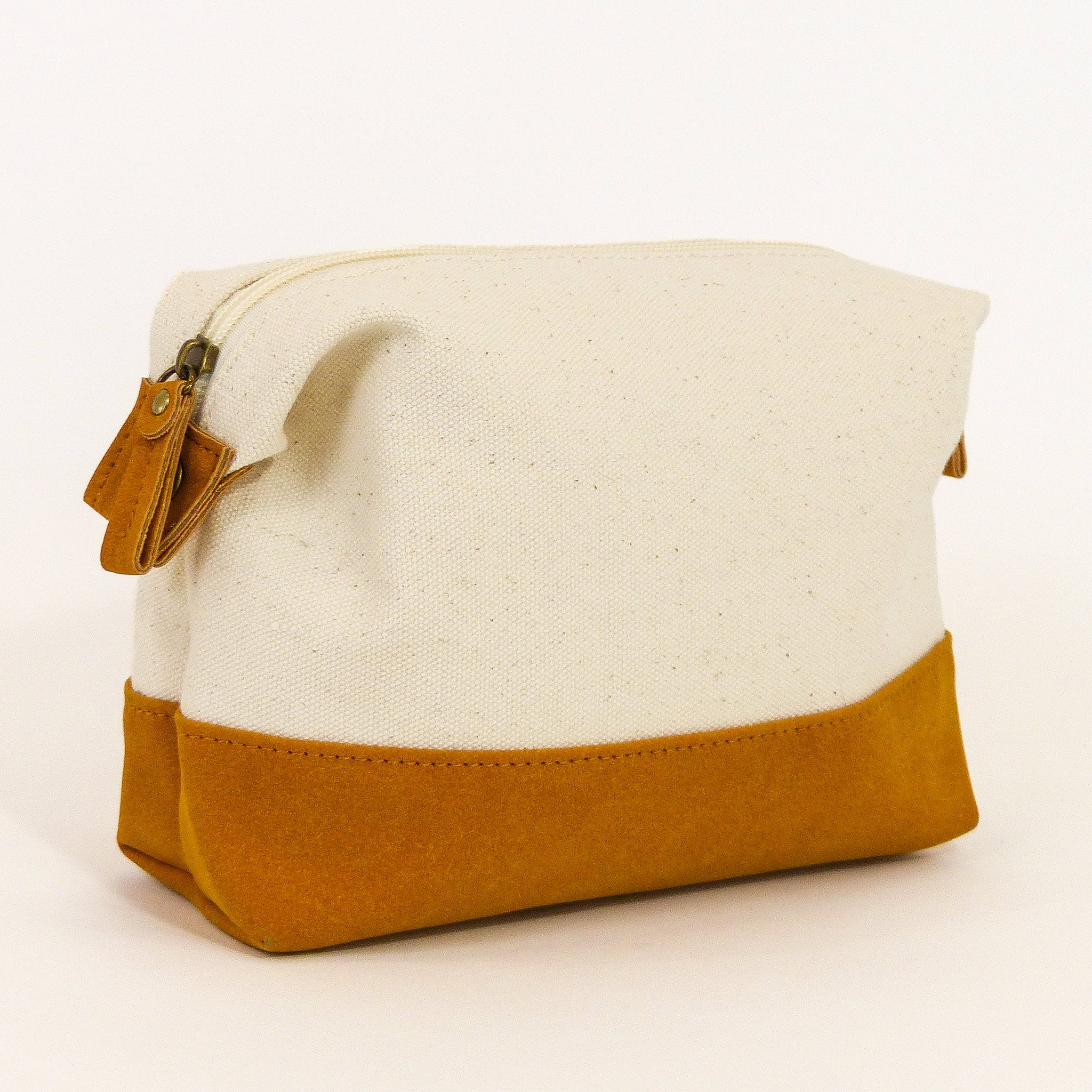 Travel Buddy Toiletry Bag in Bliss Curry/Cream, featuring a stylish design with snap-down sides and a secure zipper compartment.