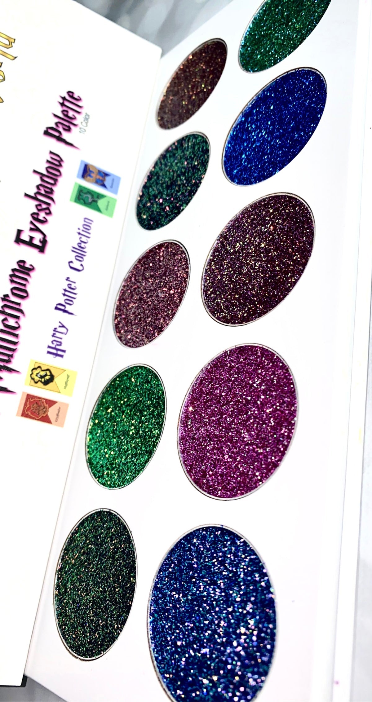 Wizarding World Chameleon Multichrome Glitter Eyeshadow Palette showcasing vibrant pinks, violets, golds, and greens in a sleek design.