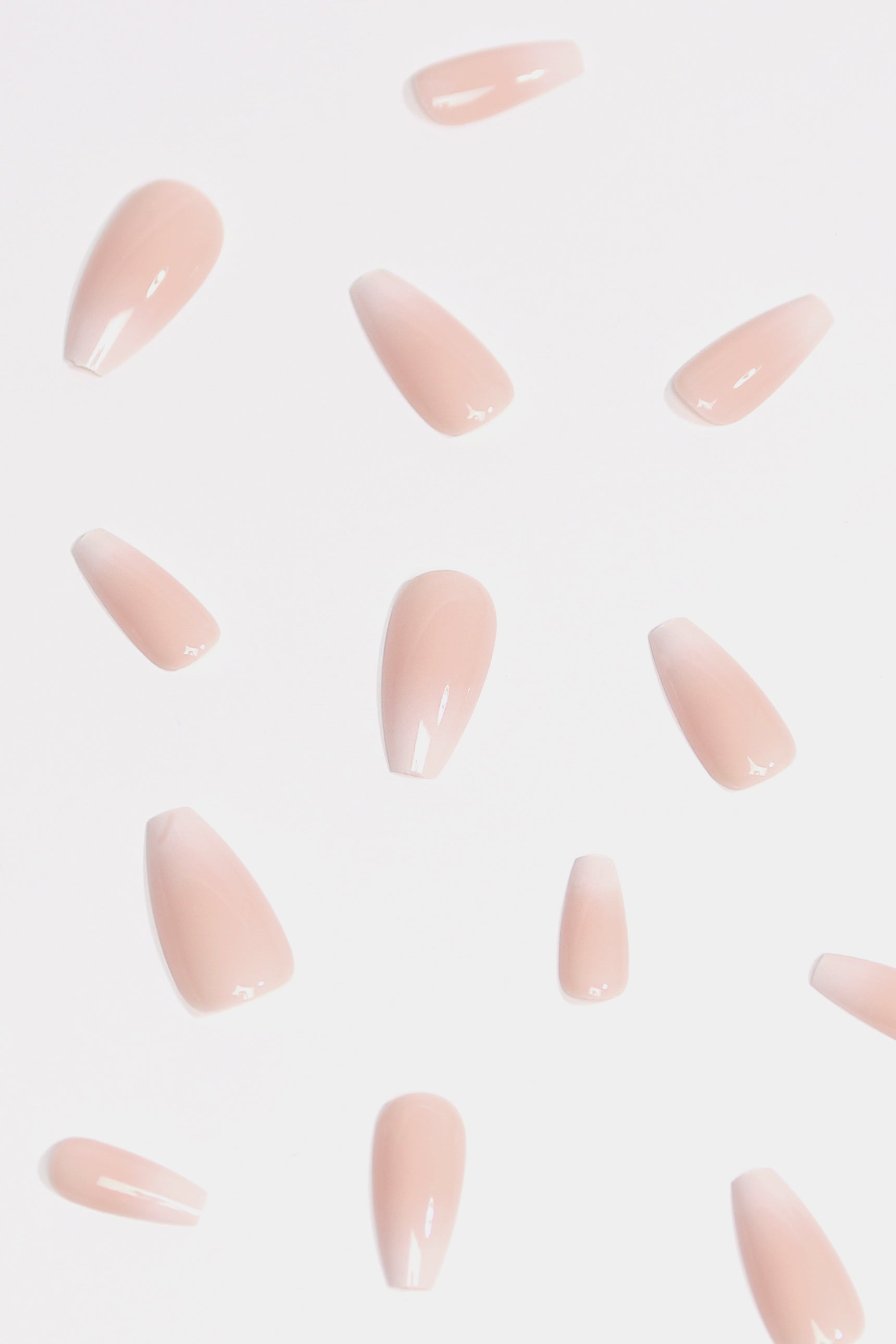 Peach Syrup press-on nails featuring a creamy peachy-coral ombre design, elegantly displayed with included accessories.