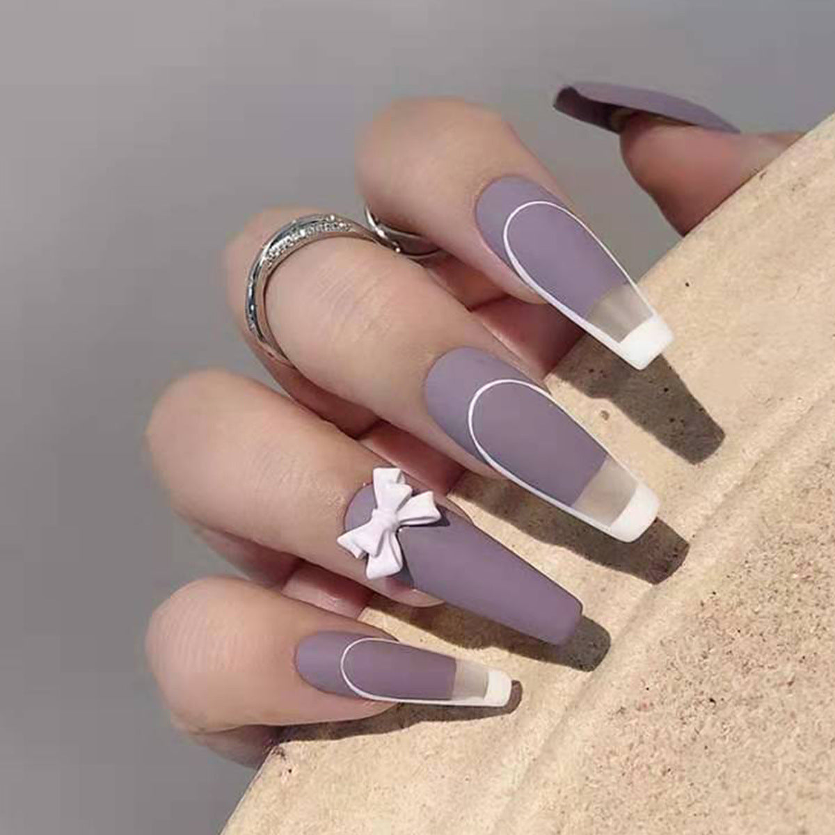 Rattan Purple French Bow Fake Nails set with 24 pieces and glue, showcasing stylish design and various sizes.