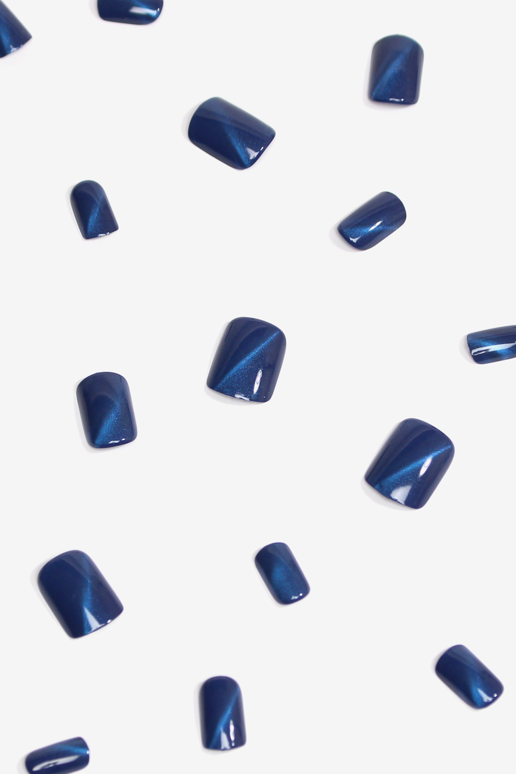 Starlite Blue Press-On Nails featuring a glittery deep blue design, showcasing various sizes and included accessories for a complete manicure.