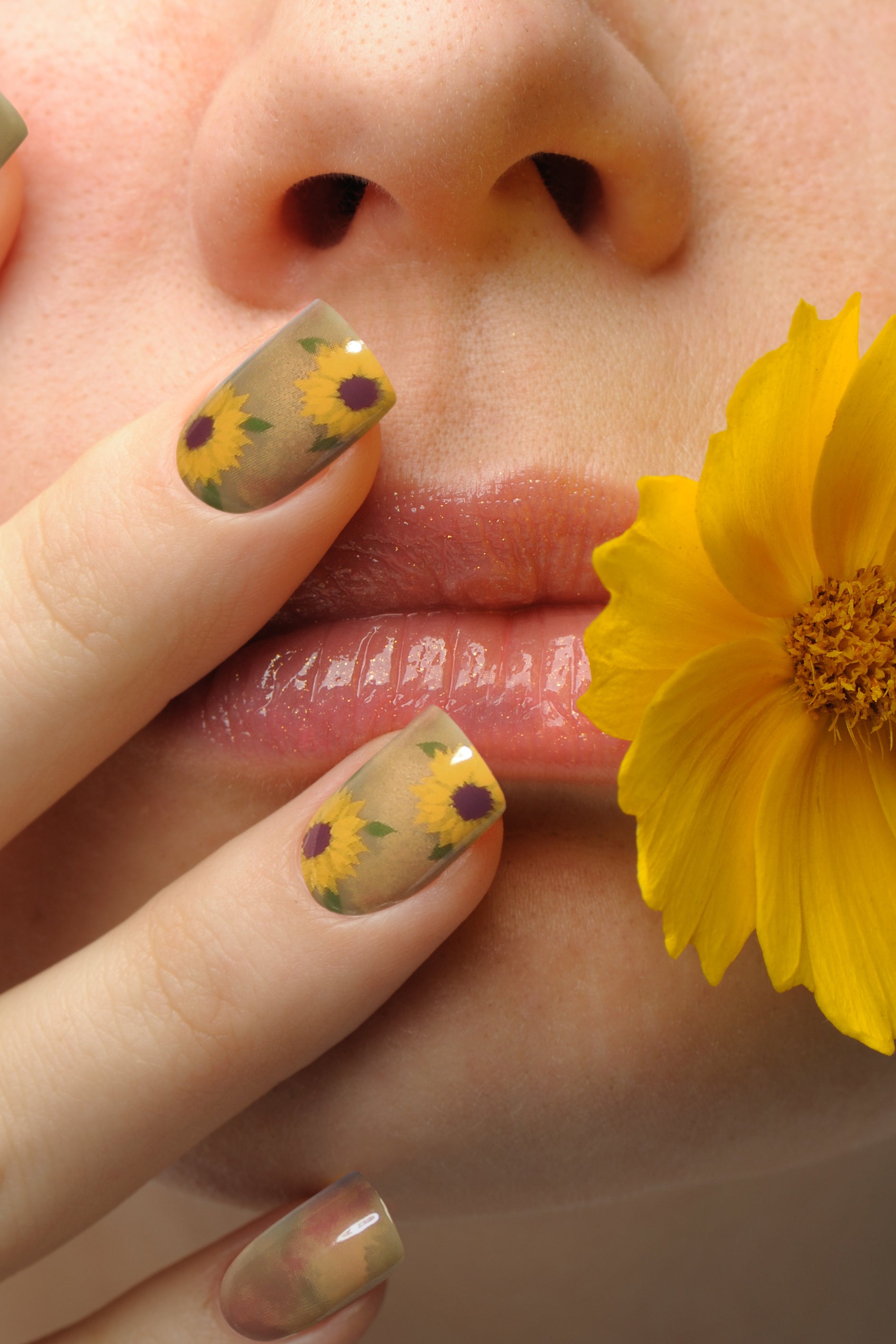 A set of Sunflower Watercolor press-on nails featuring soft, blended hues and cheerful sunflower designs, perfect for a stylish manicure.