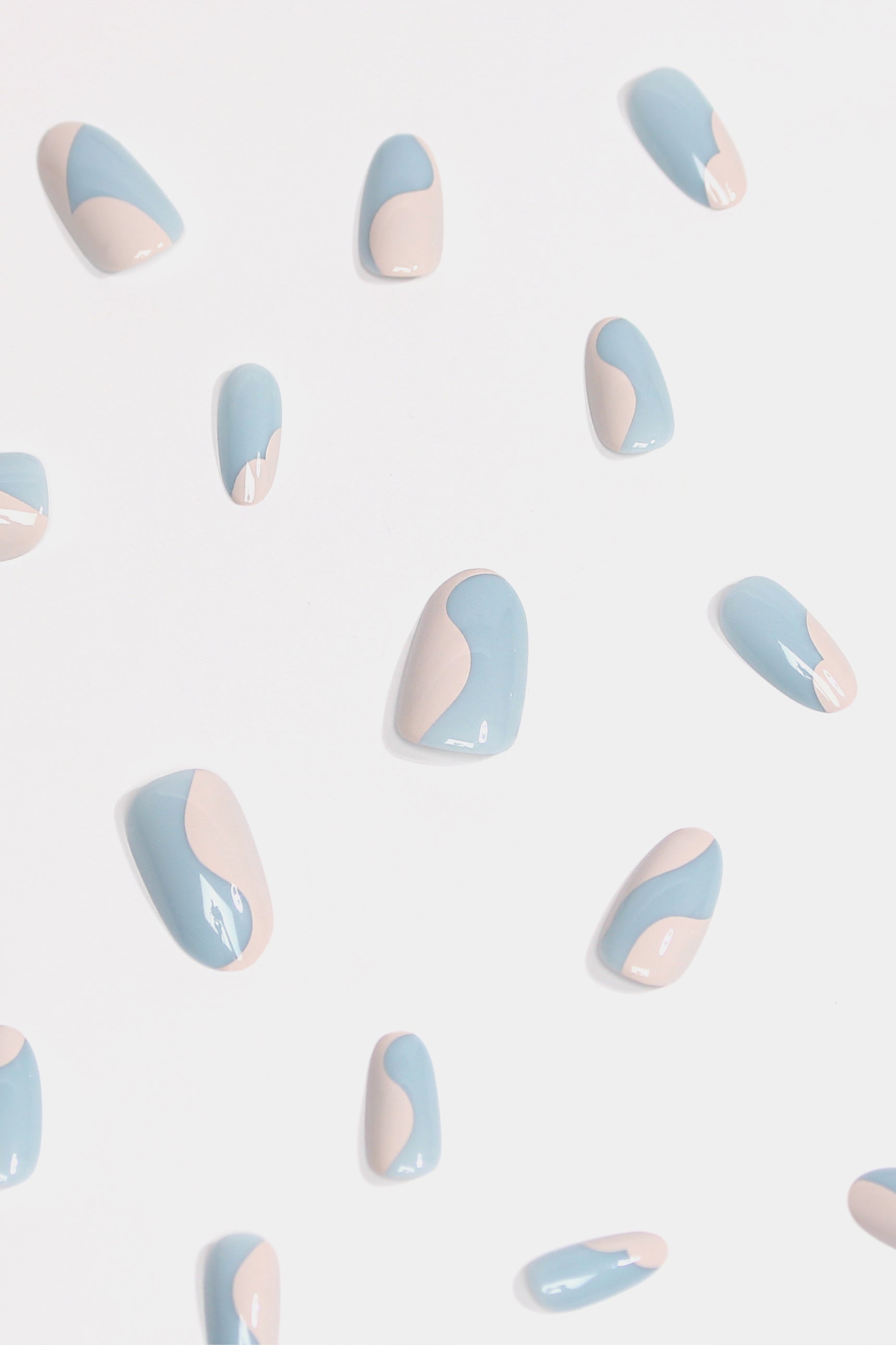 Sweet Cream press-on nails featuring pastel blue and soft neutral swirls, elegantly designed for a stylish manicure.