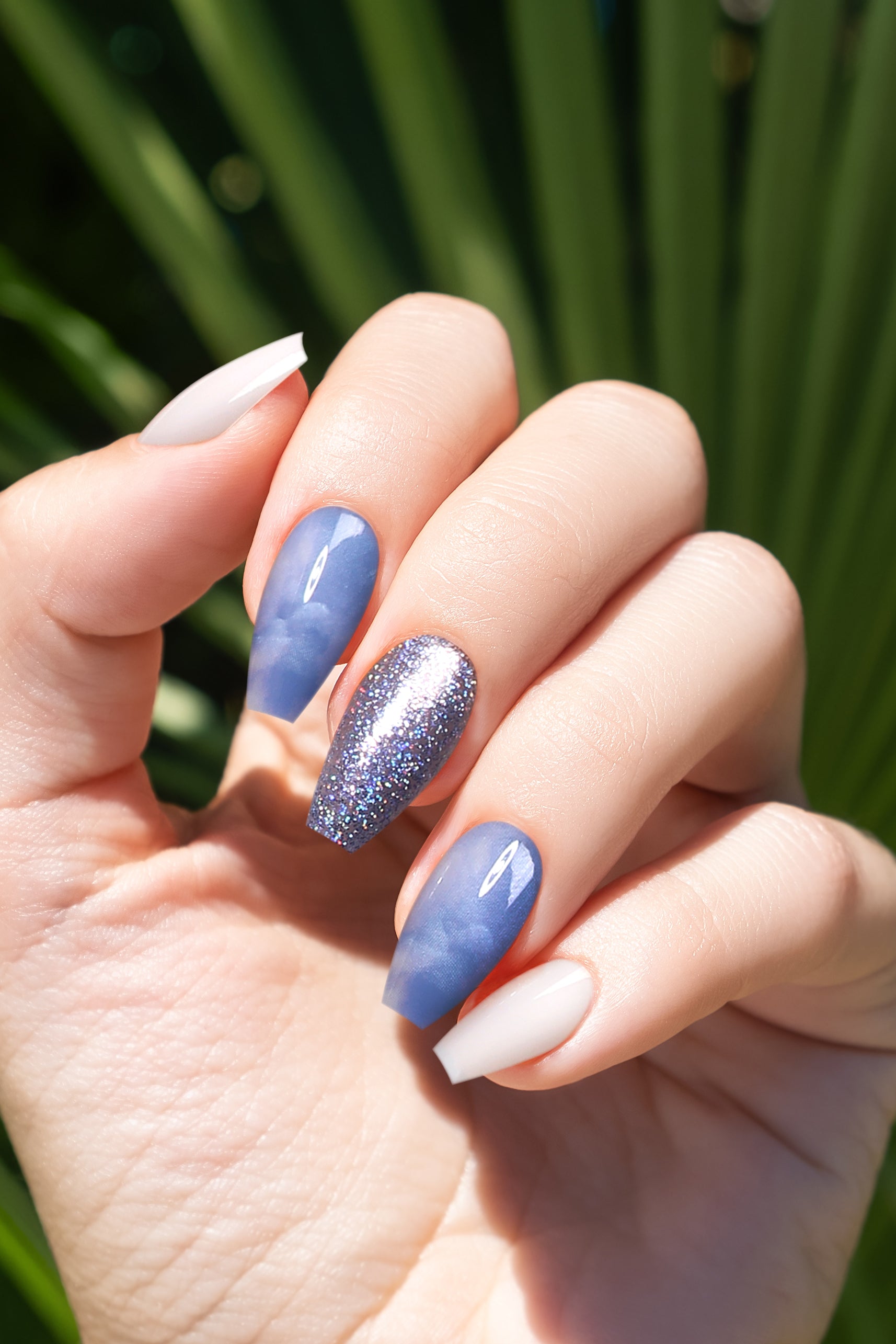 Wonderland Soft & Durable Press-On Nails featuring elegant blue marbling and light blue glitter, perfect for stylish manicures.