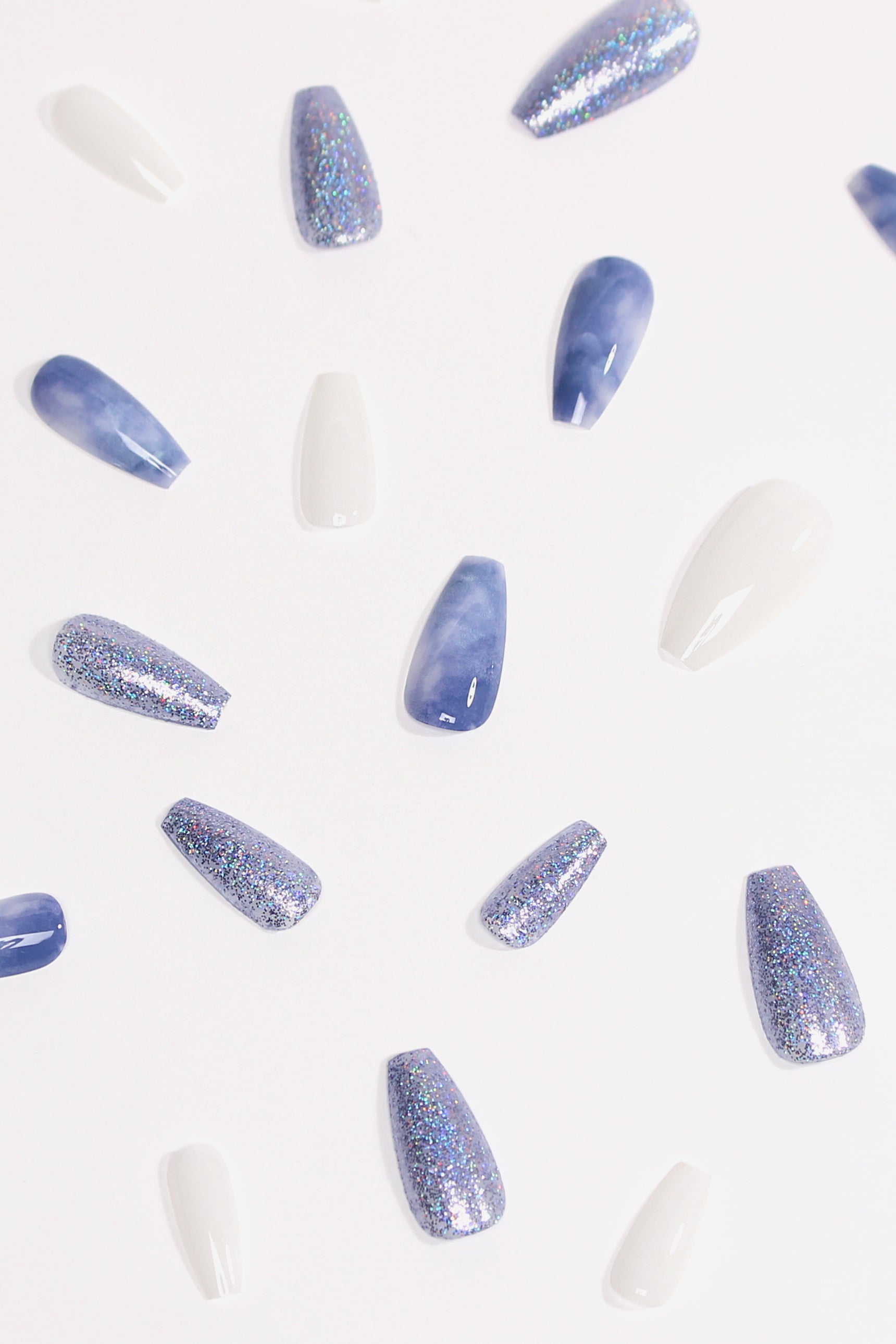 Wonderland Soft & Durable Press-On Nails featuring elegant blue marbling and light blue glitter, perfect for stylish manicures.