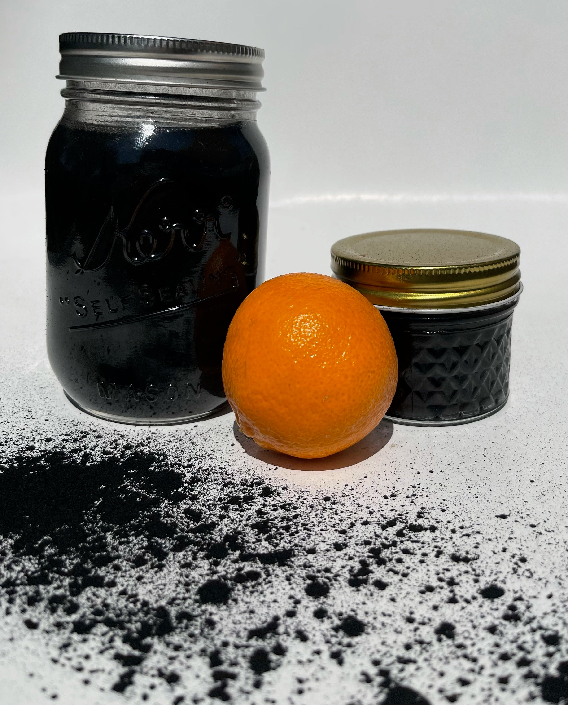 A mason jar filled with Activated Charcoal Body Wash, showcasing its rich black color and eco-friendly packaging.