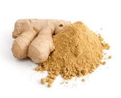 A bowl of organic African Ginger Root Powder with fresh ginger roots in the background, showcasing its rich color and texture.