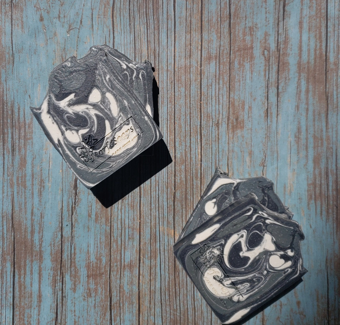 A bar of MorfoSoaps' All Natural Eucalyptus Soap, showcasing its unique color and texture, made with eucalyptus oil and activated charcoal.