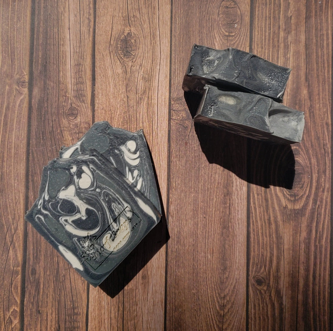 A bar of MorfoSoaps' All Natural Eucalyptus Soap, showcasing its unique color and texture, made with eucalyptus oil and activated charcoal.