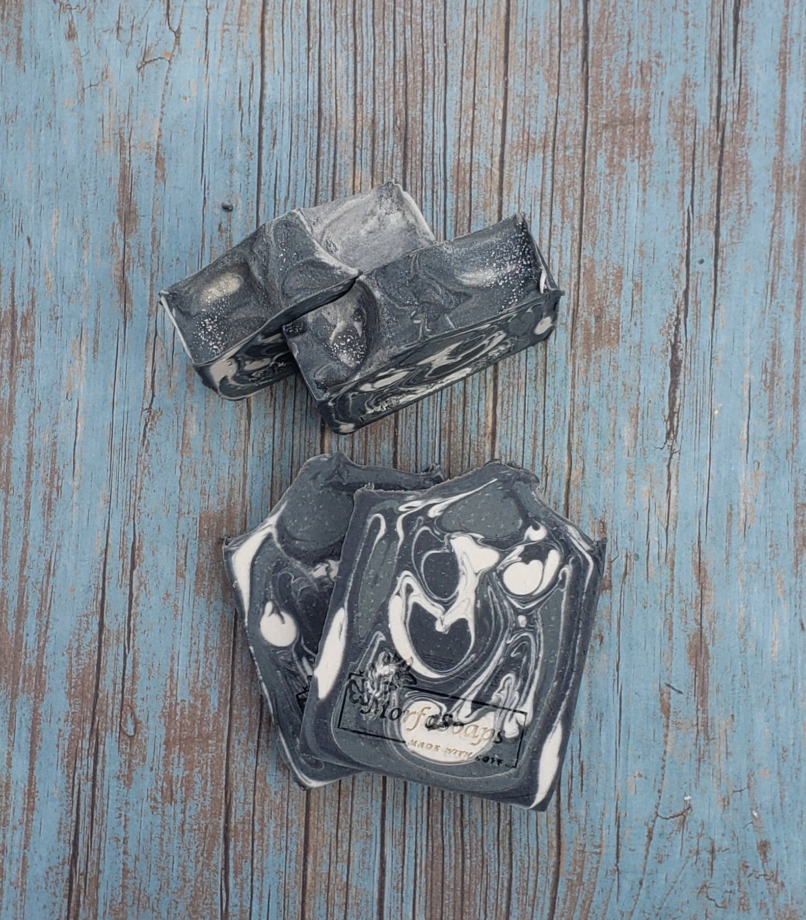 A bar of MorfoSoaps' All Natural Eucalyptus Soap, showcasing its unique color and texture, made with eucalyptus oil and activated charcoal.