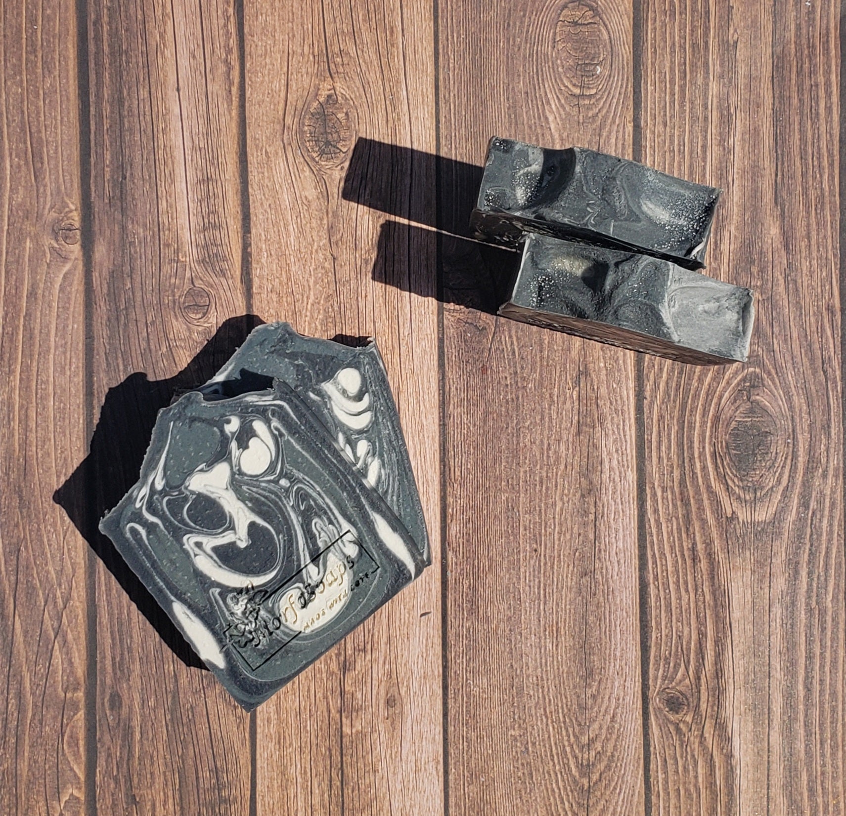 A bar of MorfoSoaps' All Natural Eucalyptus Soap, showcasing its unique color and texture, made with eucalyptus oil and activated charcoal.