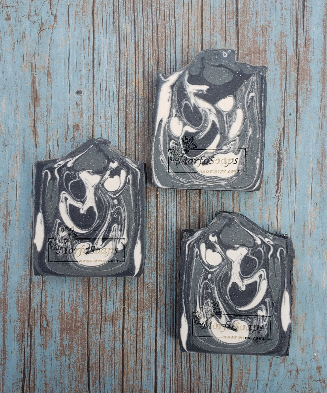 A bar of MorfoSoaps' All Natural Eucalyptus Soap, showcasing its unique color and texture, made with eucalyptus oil and activated charcoal.